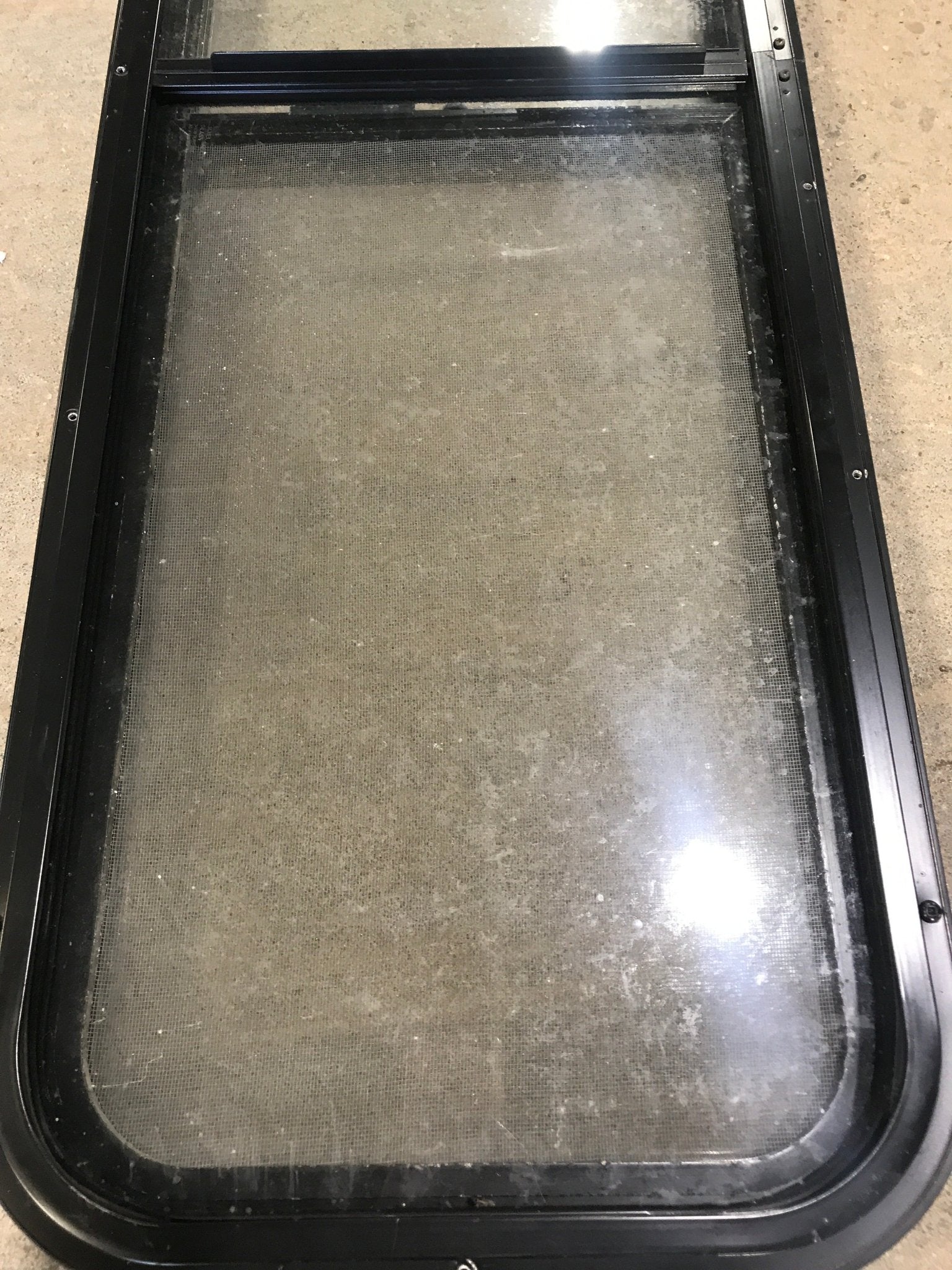 Used Black Radius Opening Window : 49" W x 15 1/4" H x 2" D - Young Farts RV Parts