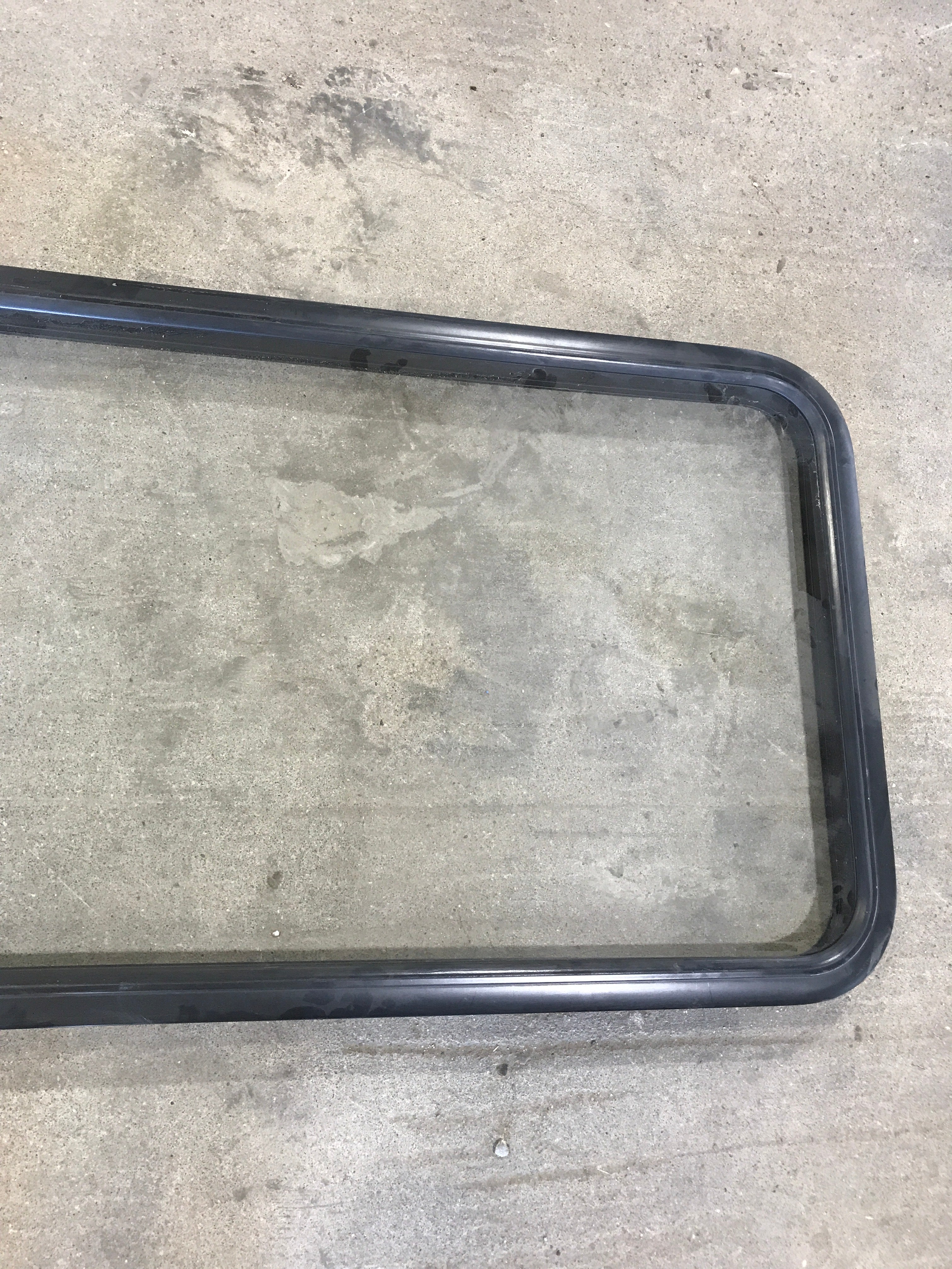 Used Black Radius Opening Window : 23 1/2" W x 52" H x 1 7/8" - Young Farts RV Parts
