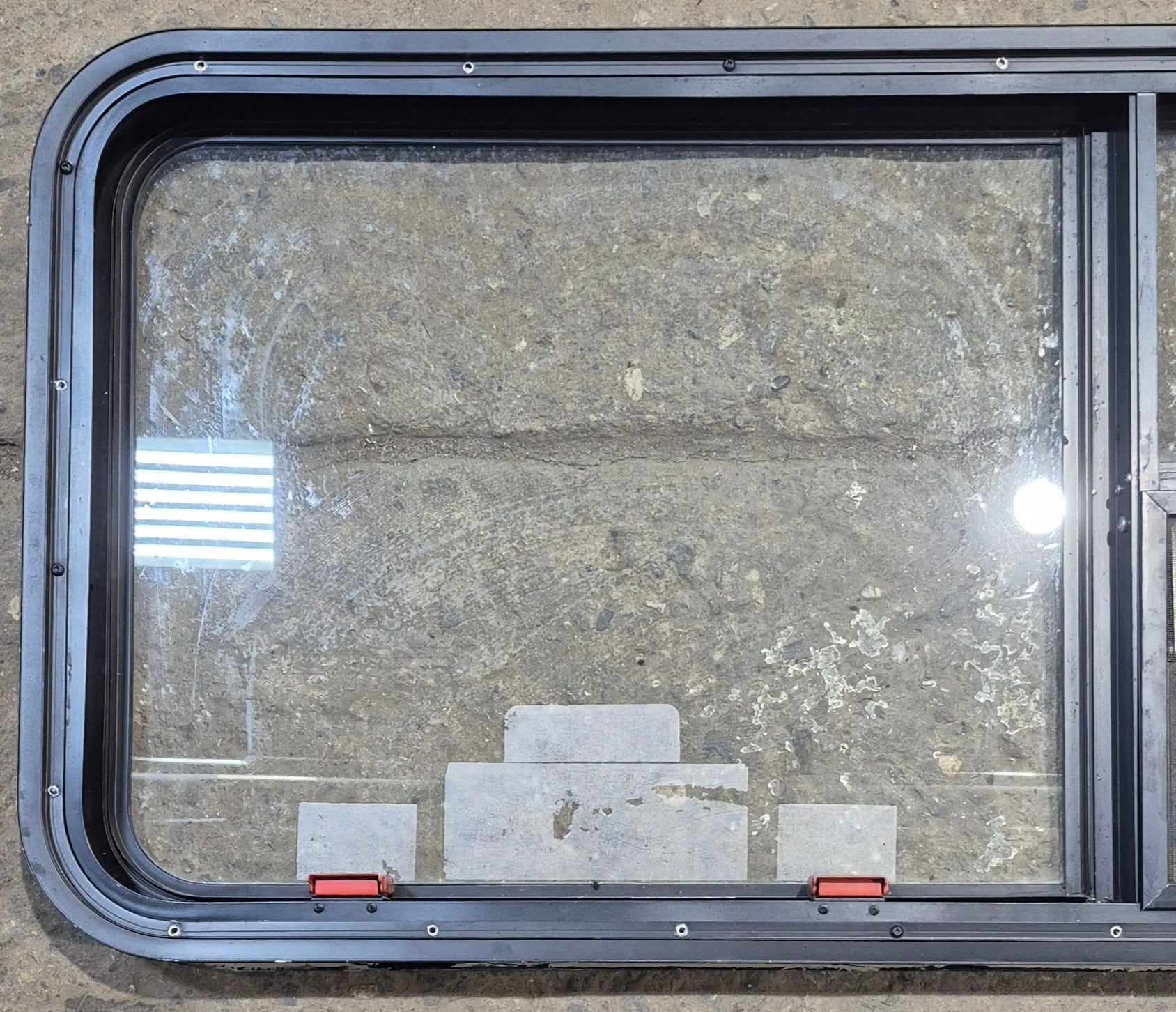 Used Black Emergency Radius Opening Window : 59 1/4" W x 21 1/4" H x 1 7/8" - Young Farts RV Parts