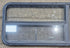 Used Black Emergency Radius Opening Window : 59 1/4" W x 21 1/4" H x 1 7/8" - Young Farts RV Parts