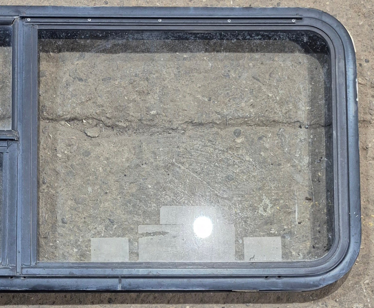 Used Black Emergency Radius Opening Window : 59 1/4" W x 21 1/4" H x 1 7/8" - Young Farts RV Parts