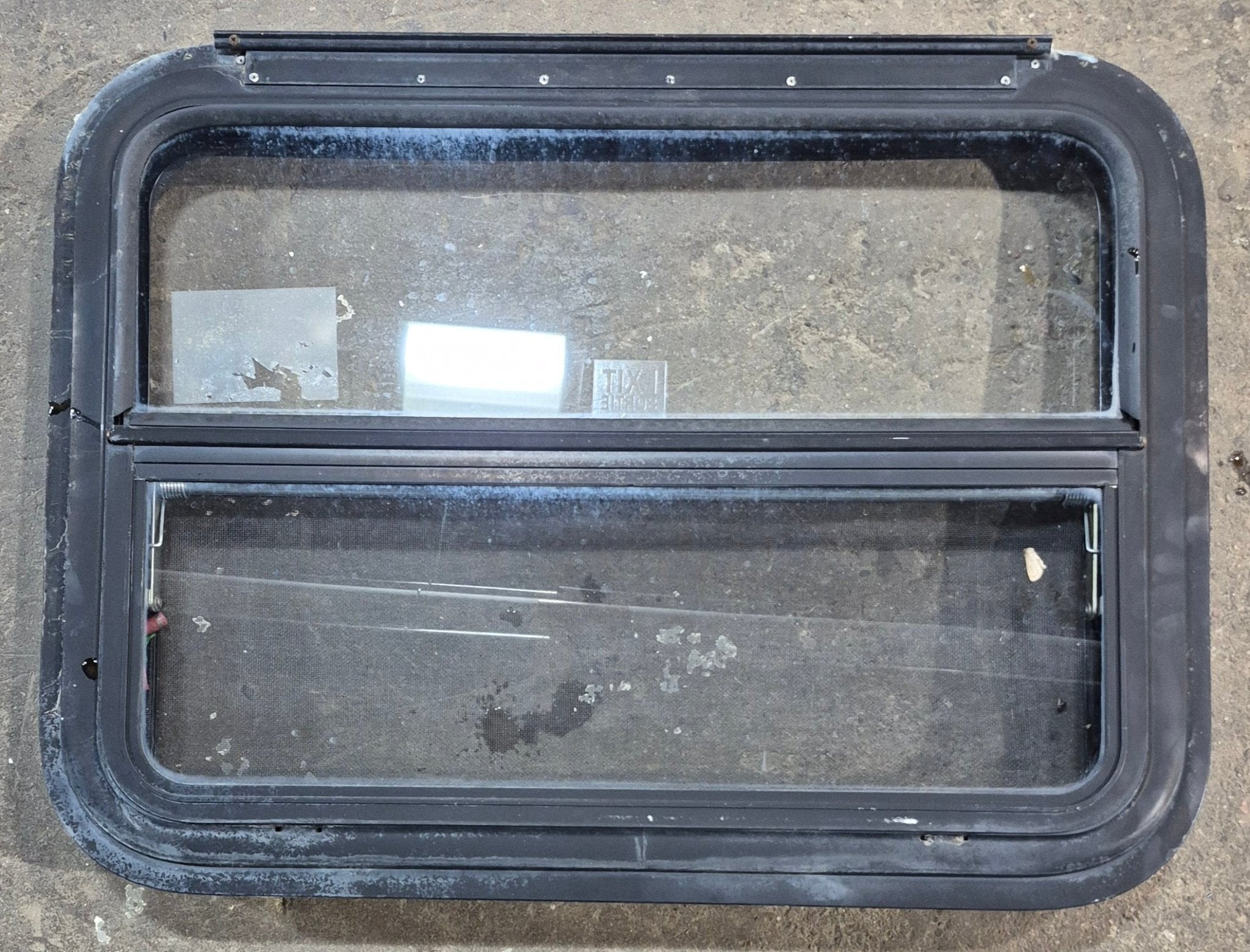 Used Black Radius Emergency Opening Window : 29 1/4" W x 21 1/4" H x 1 1/2" - Young Farts RV Parts