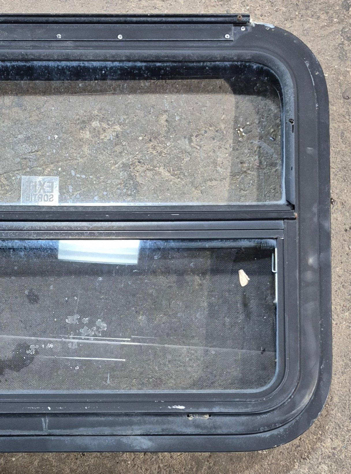 Used Black Radius Emergency Opening Window : 29 1/4" W x 21 1/4" H x 1 1/2" - Young Farts RV Parts