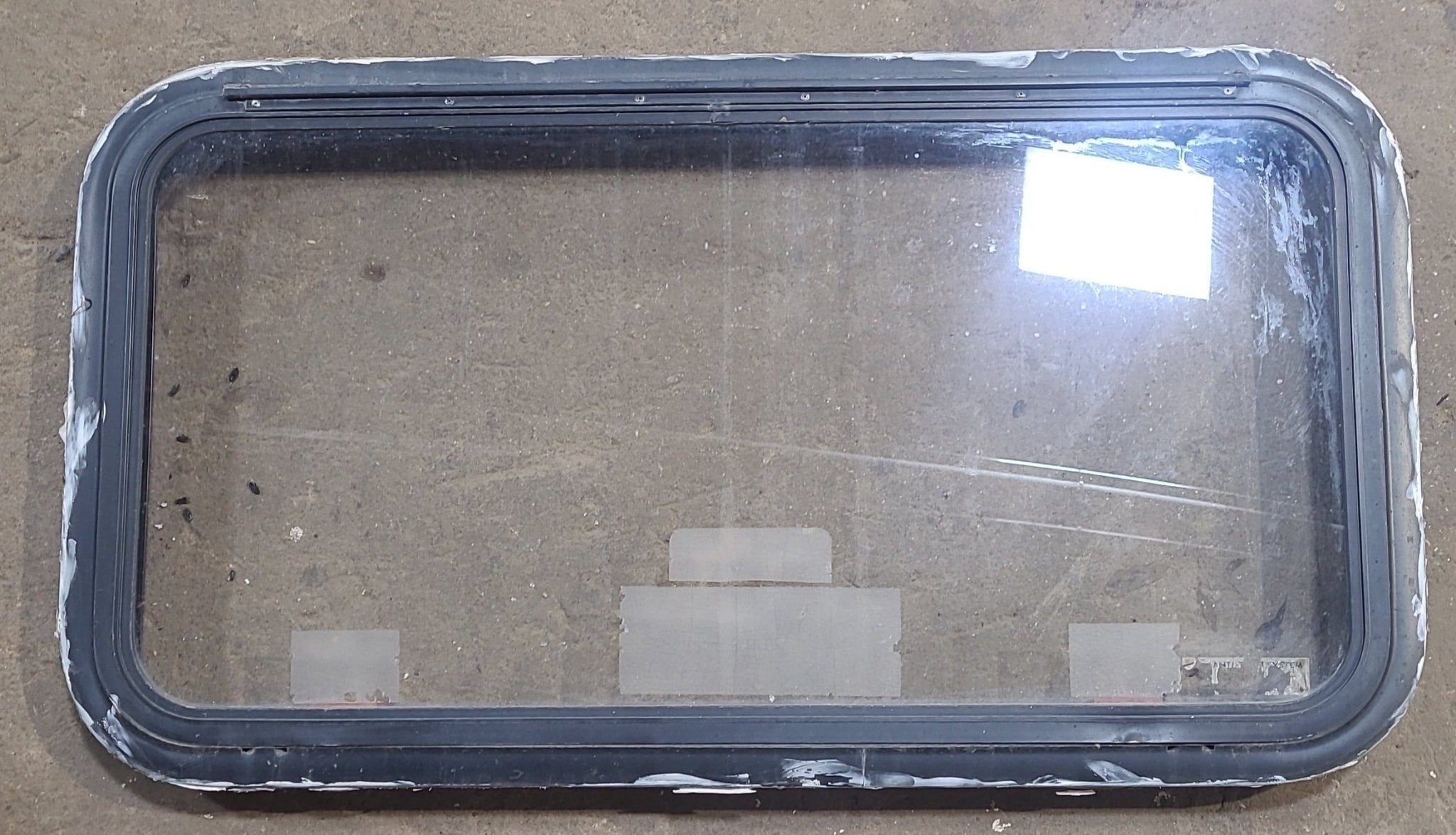 Used Black Radius Emergency Opening Window : 35 1/2" W x 18 1/2" H x 1 7/8" D - Young Farts RV Parts