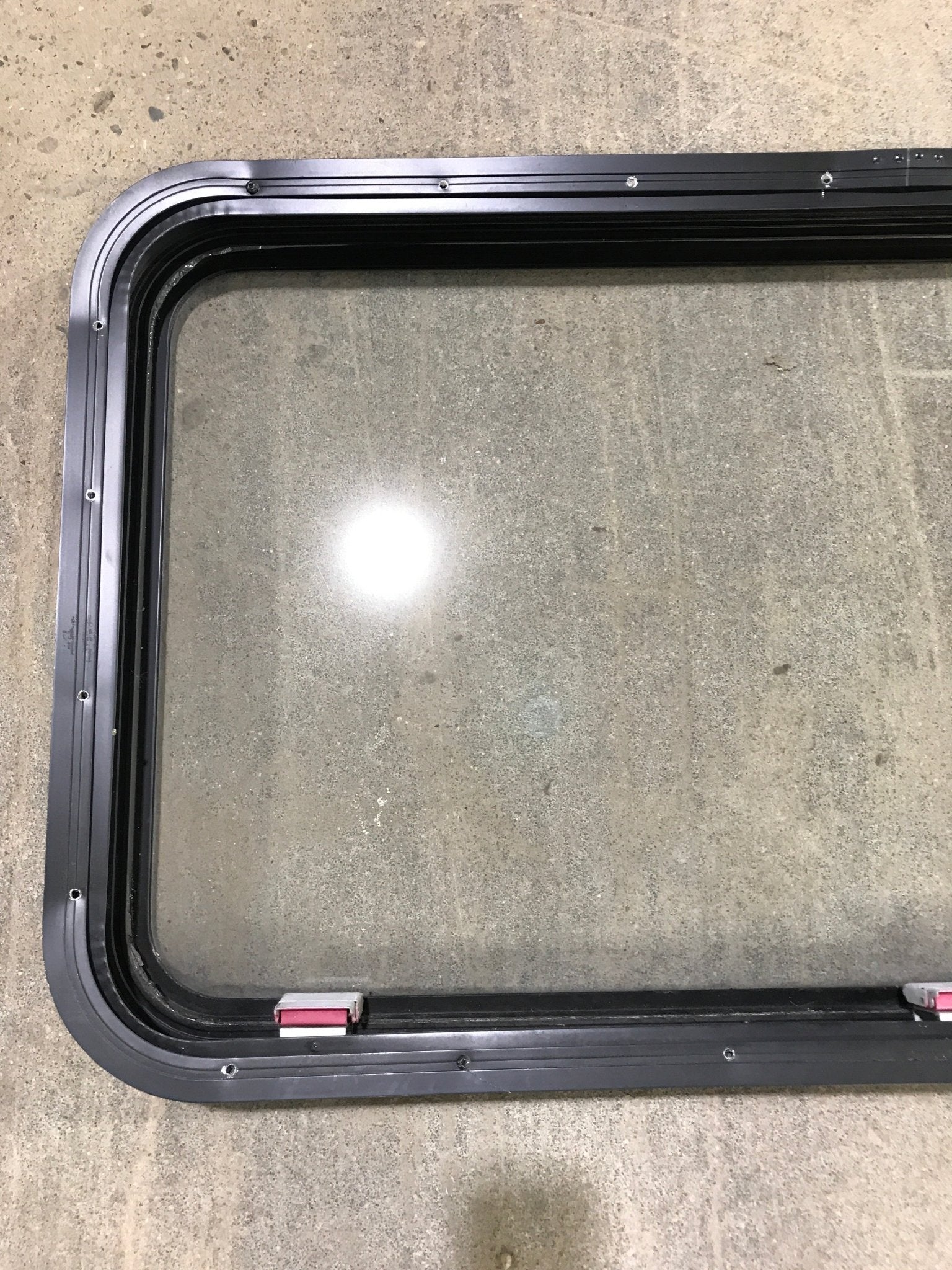 Used Black Radius Emergency Opening Window : 41 1/2" W x 21 1/2" H x 2" D - Young Farts RV Parts