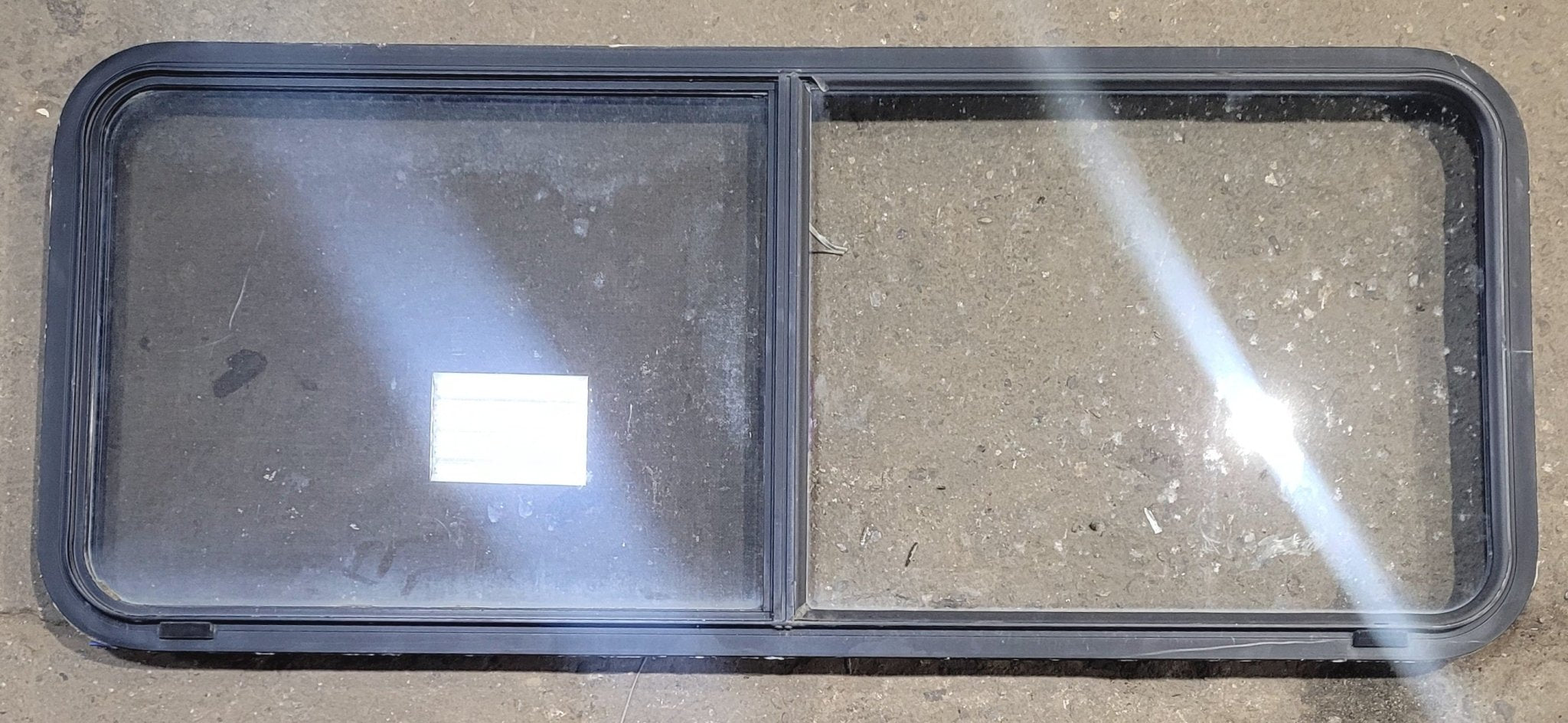 Used Black Radius Emergency Opening Window : 54 1/4" W x 21 3/4" H x 1 3/4" - Young Farts RV Parts