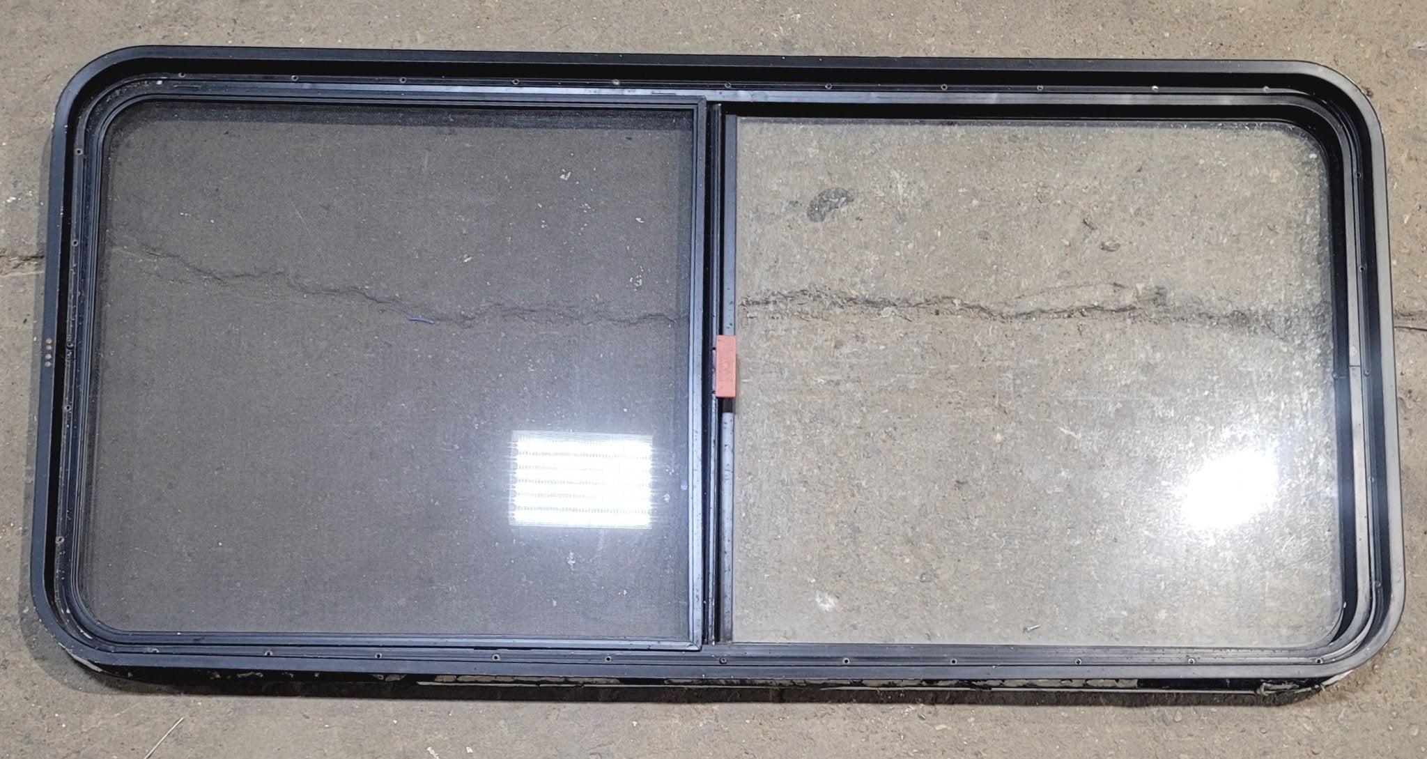 Used Black Radius Emergency Opening Window : 55 1/4" W x 25 1/2" H x 1 7/8" - Young Farts RV Parts