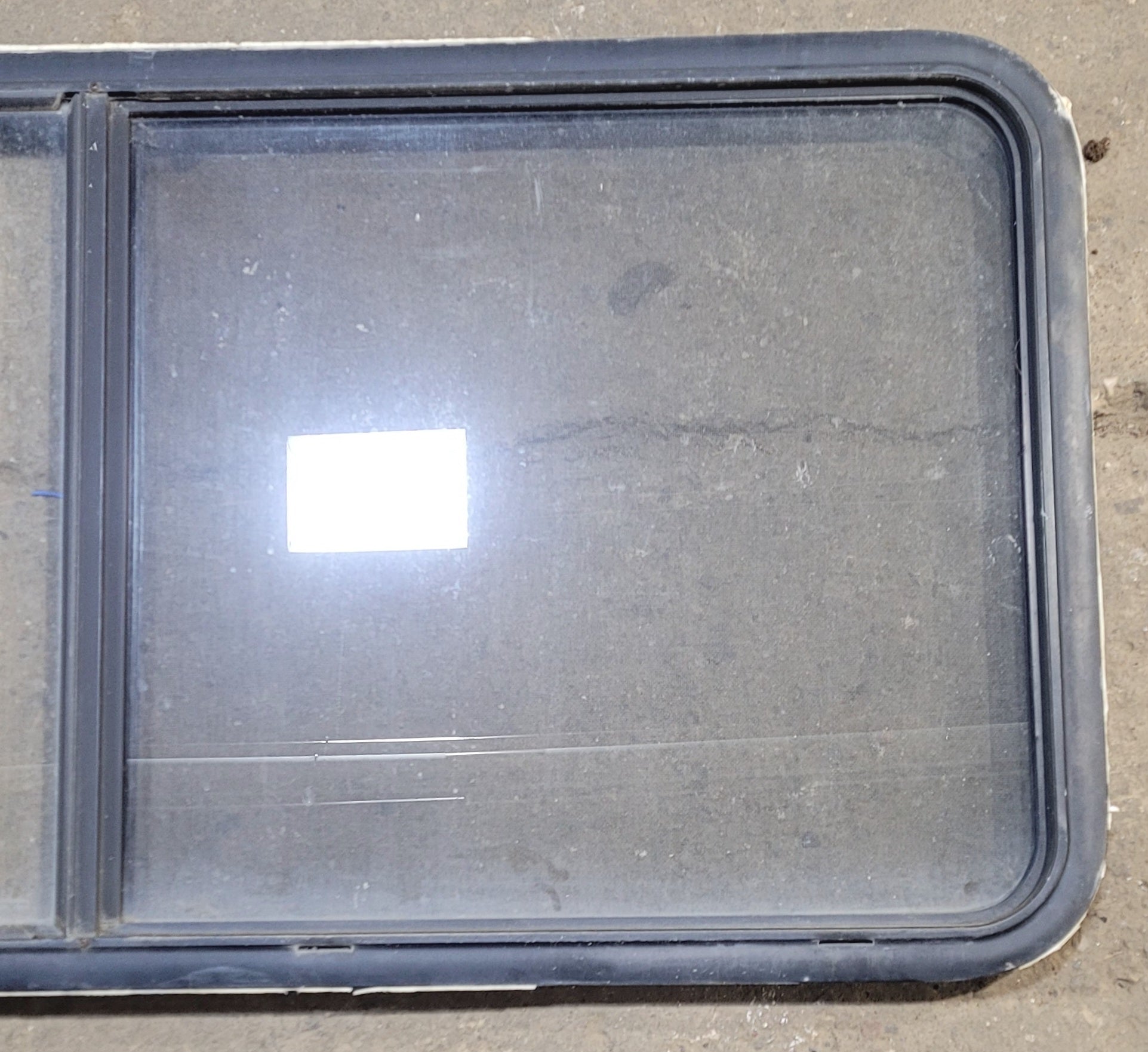 Used Black Radius Emergency Opening Window : 55 1/4" W x 25 1/2" H x 1 7/8" - Young Farts RV Parts