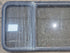 Used Black Radius Emergency Opening Window : 57 1/2" W x 21 3/4" H x 1 1/4" - Young Farts RV Parts