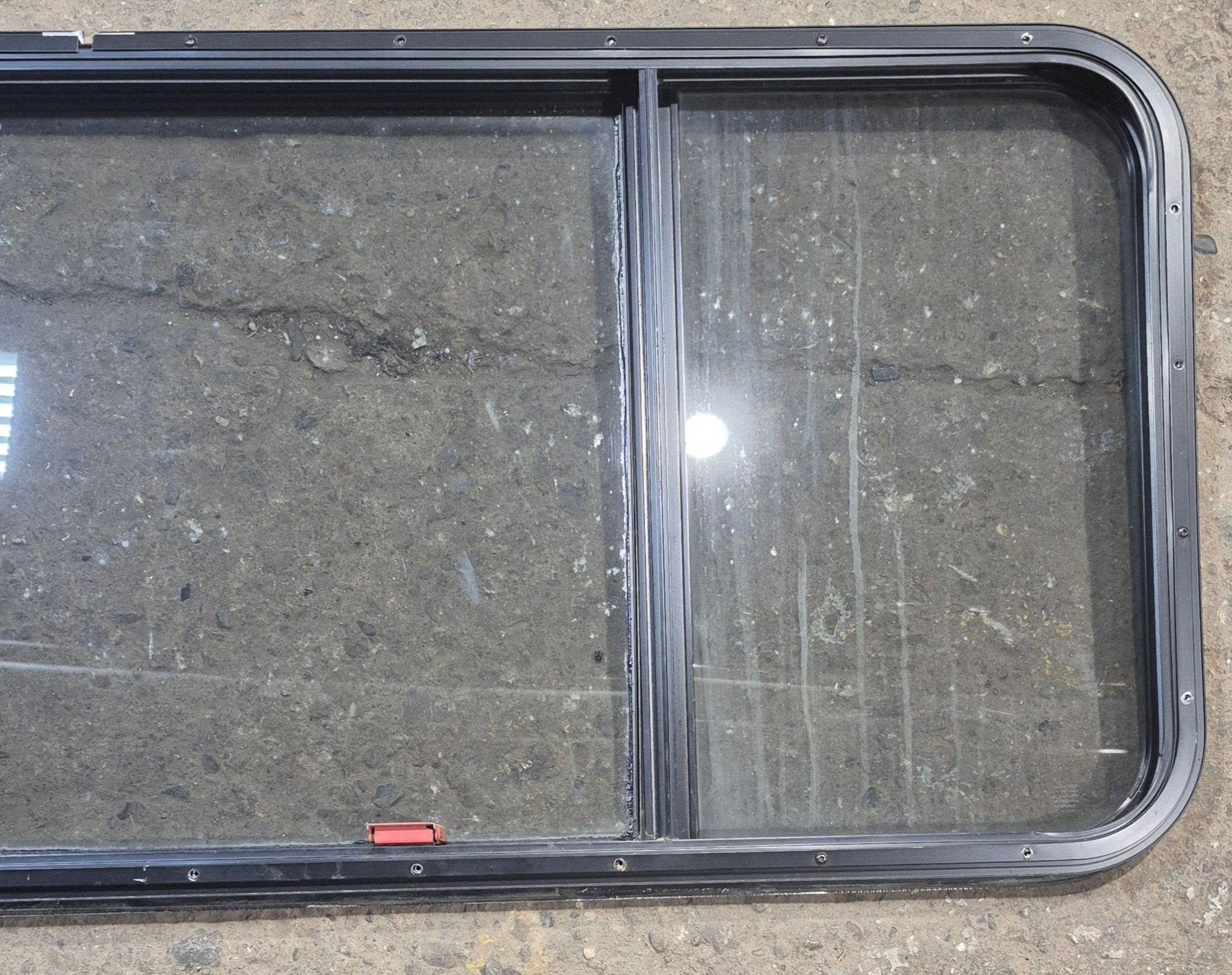 Used Black Radius Emergency Opening Window : 57 1/2" W x 21 3/4" H x 1 1/4" - Young Farts RV Parts