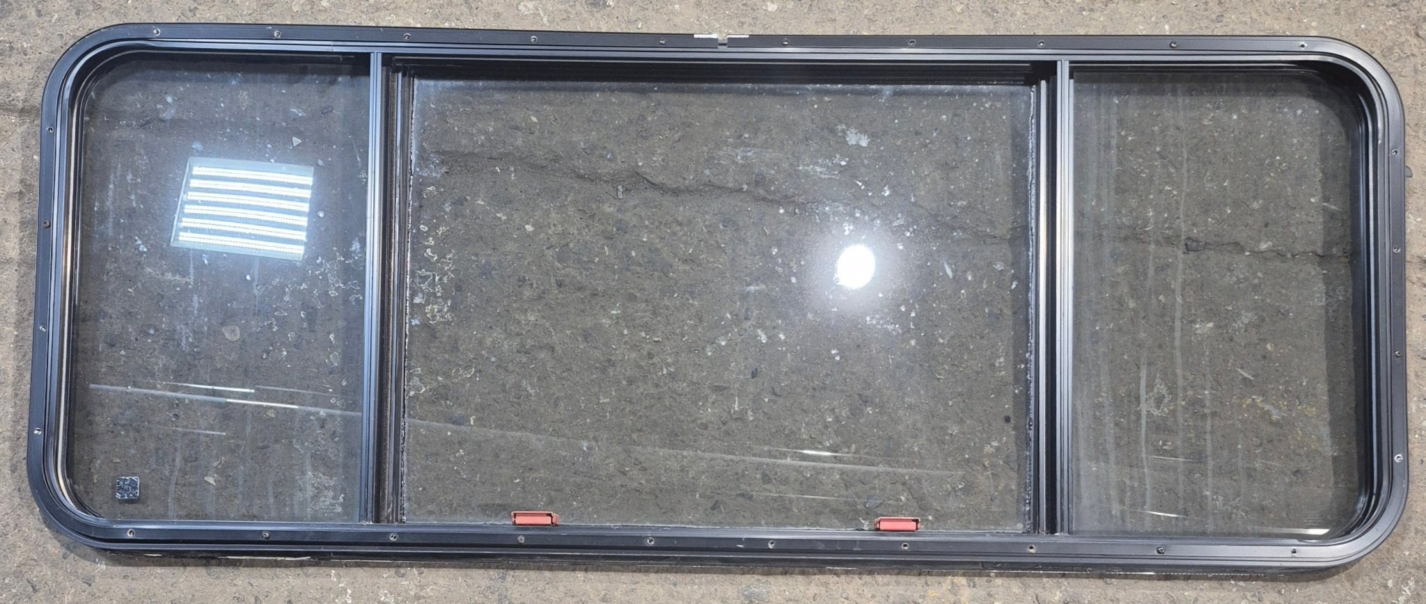 Used Black Radius Emergency Opening Window : 57 1/2" W x 21 3/4" H x 1 1/4" - Young Farts RV Parts