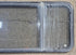 Used Black Radius Emergency Opening Window : 57 1/2" W x 21 3/4" H x 1 1/4" - Young Farts RV Parts