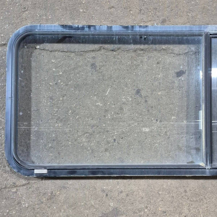 Used Black Radius Emergency Opening Window - 60.25 X 21.75 X 1.75 - Young Farts RV Parts