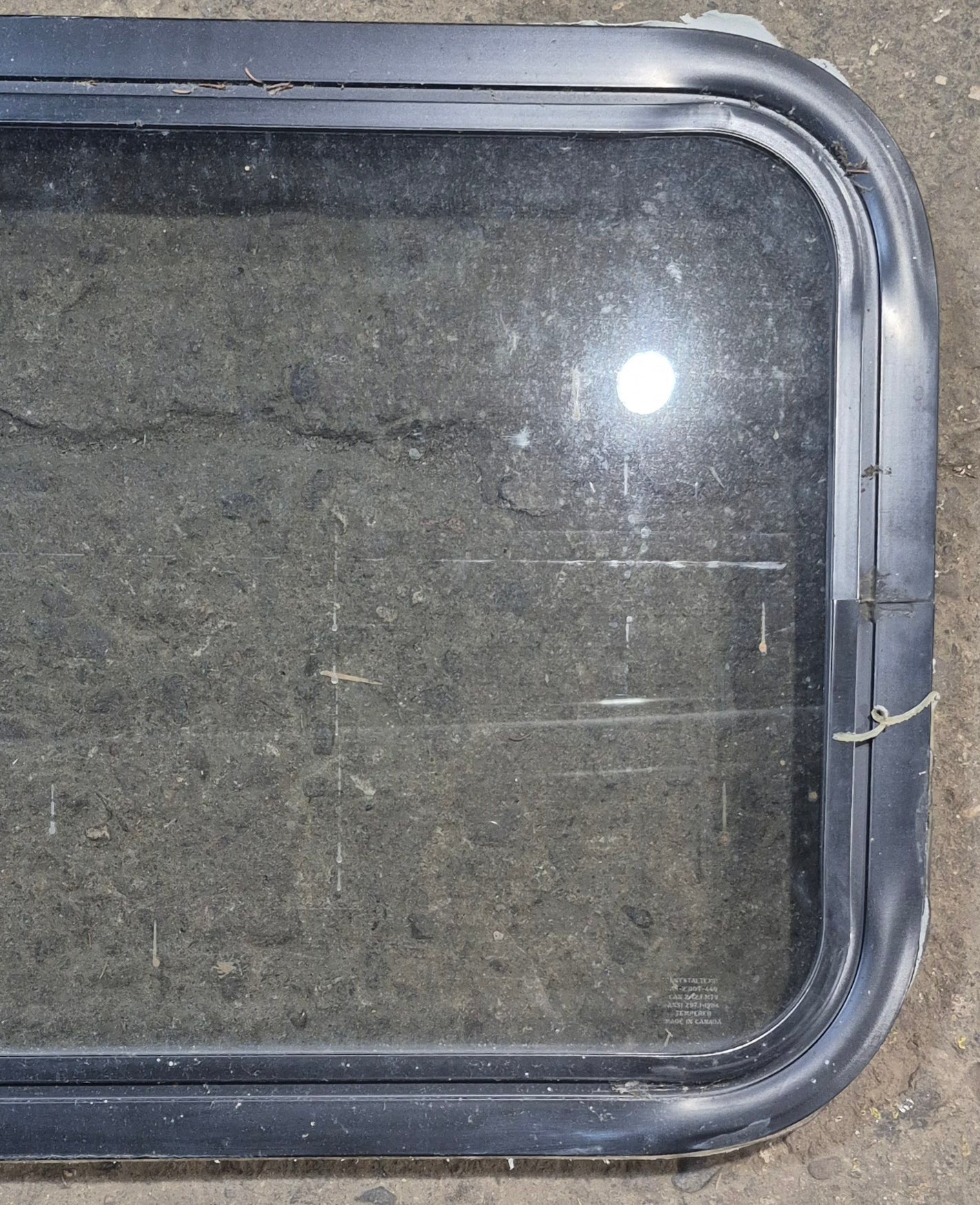 Used Black Radius Non Opening Window : 24 1/4" W x 16 3/4" H x 1 7/8" - Young Farts RV Parts
