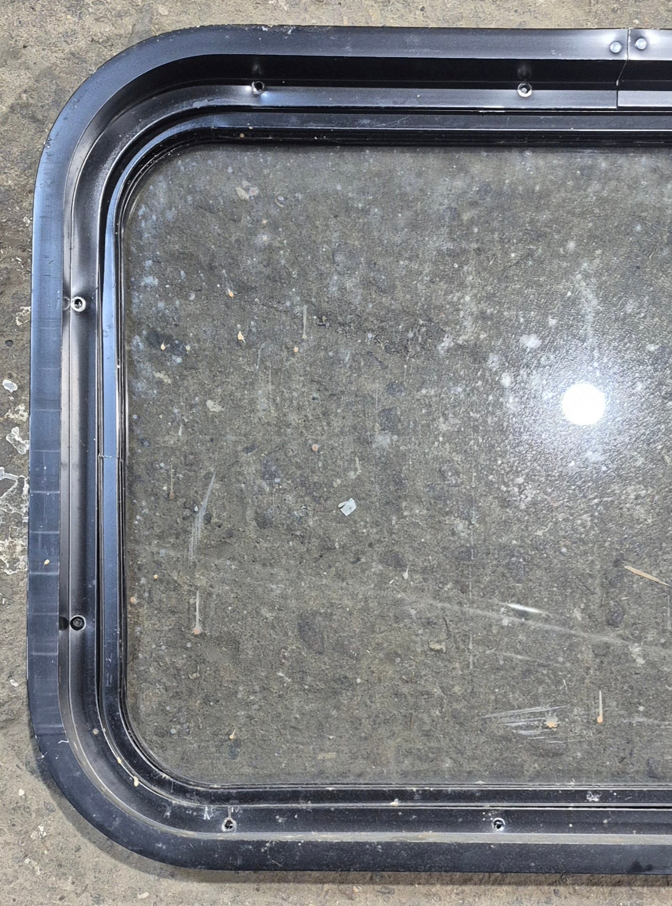 Used Black Radius Non Opening Window : 24 1/4" W x 16 3/4" H x 1 7/8" - Young Farts RV Parts