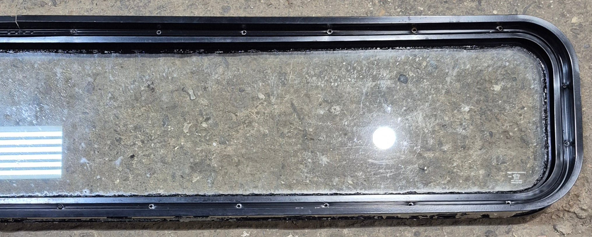 Used Black Radius Non Opening Window : 72 1/4" W x 11 3/4" H x 1 7/8" - Young Farts RV Parts
