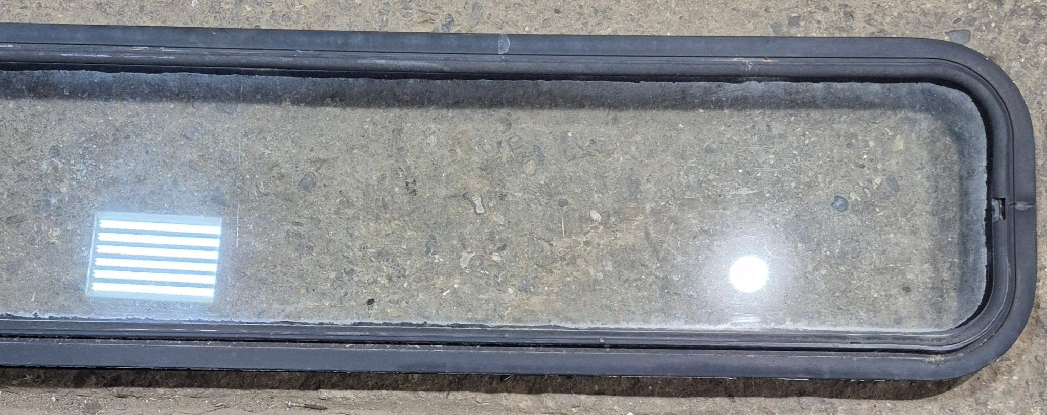 Used Black Radius Non Opening Window : 72 1/4" W x 11 3/4" H x 1 7/8" - Young Farts RV Parts