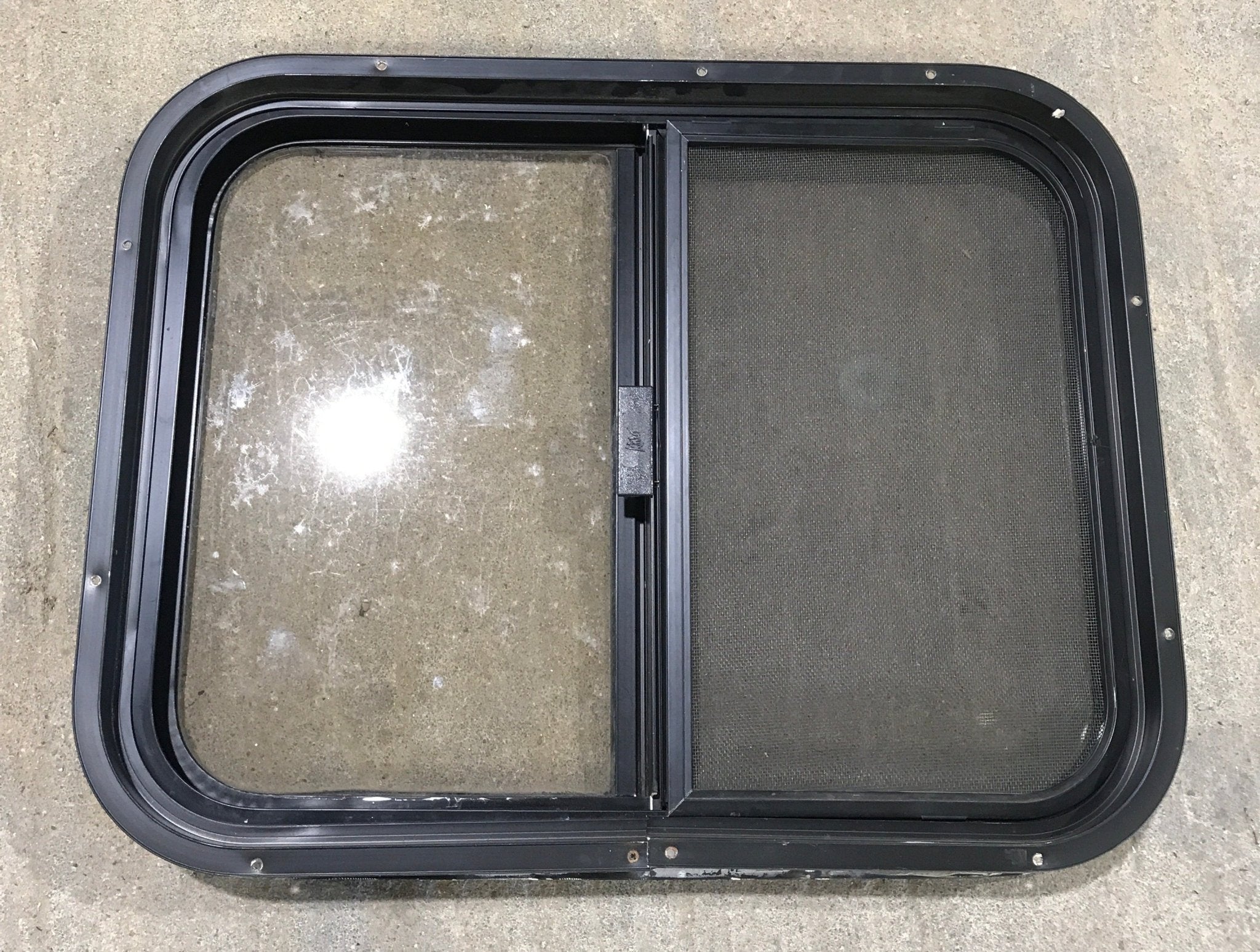 Used Black Radius Opening Window : 24 1/2" W x 19 1/4" H x 1 1/4" - Young Farts RV Parts