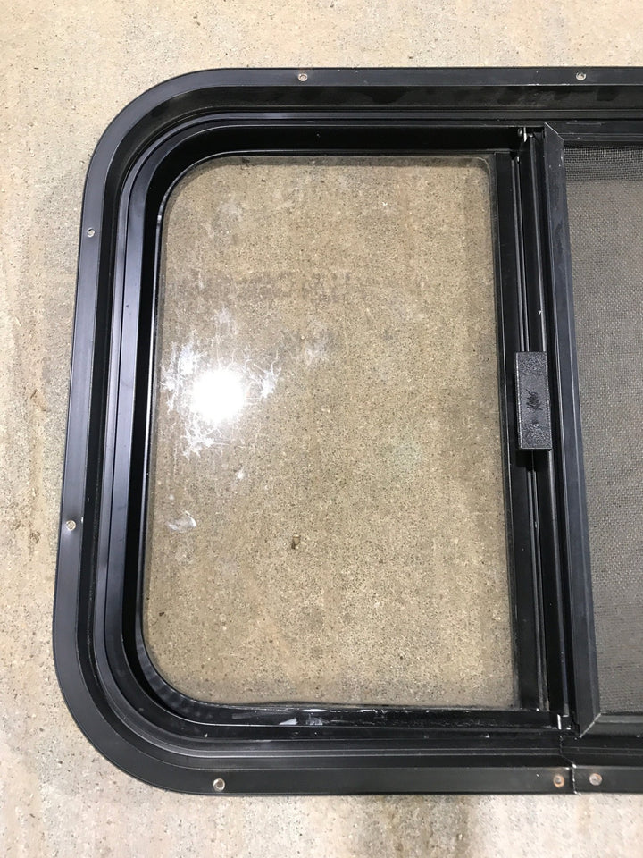 Used Black Radius Opening Window : 24 1/2" W x 19 1/4" H x 1 1/4" - Young Farts RV Parts