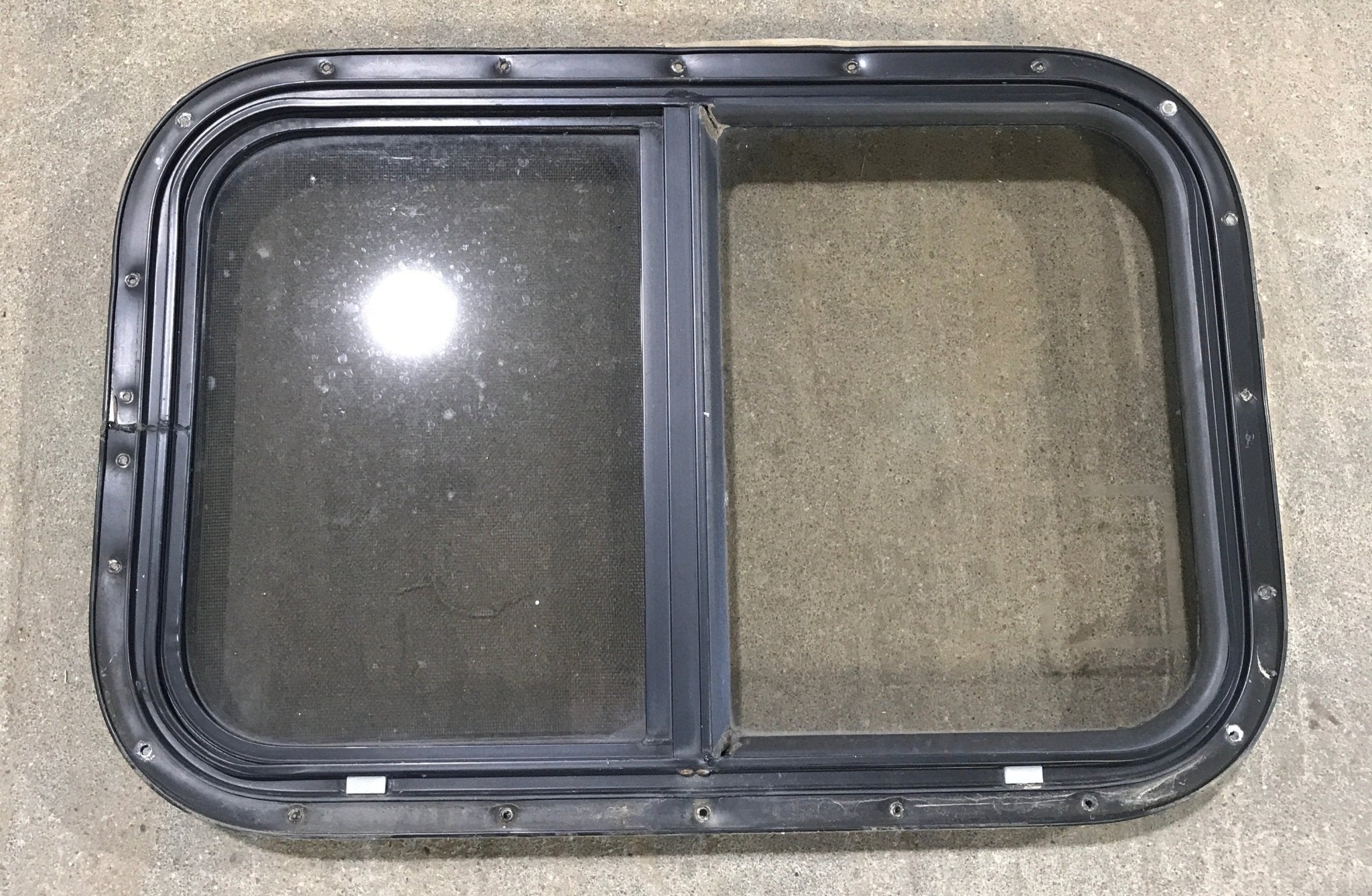 Used Black Radius Opening Window : 24 1/2" W x 19 1/4" H x 1 1/4" - Young Farts RV Parts