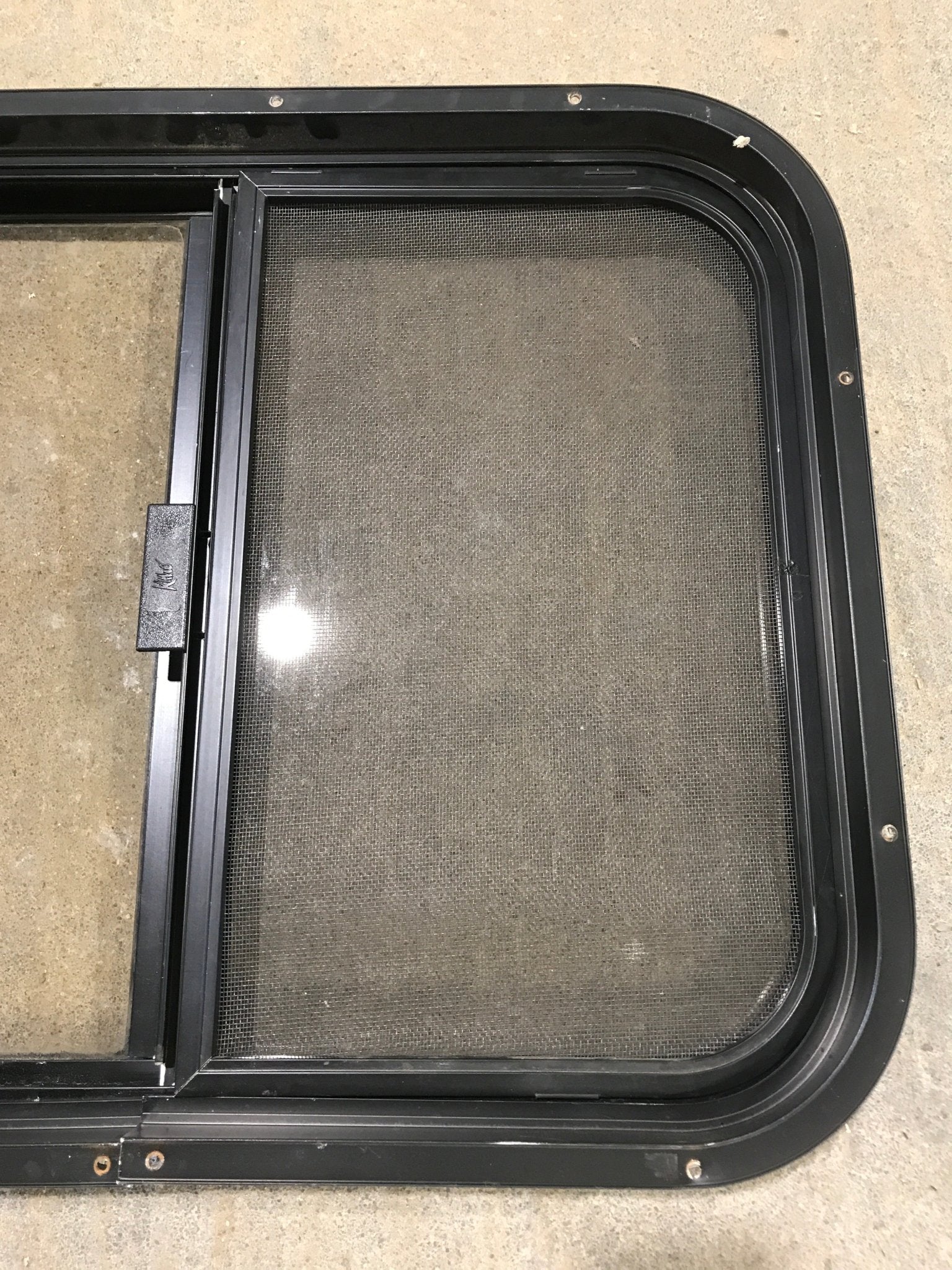 Used Black Radius Opening Window : 24 1/2" W x 19 1/4" H x 1 1/4" - Young Farts RV Parts