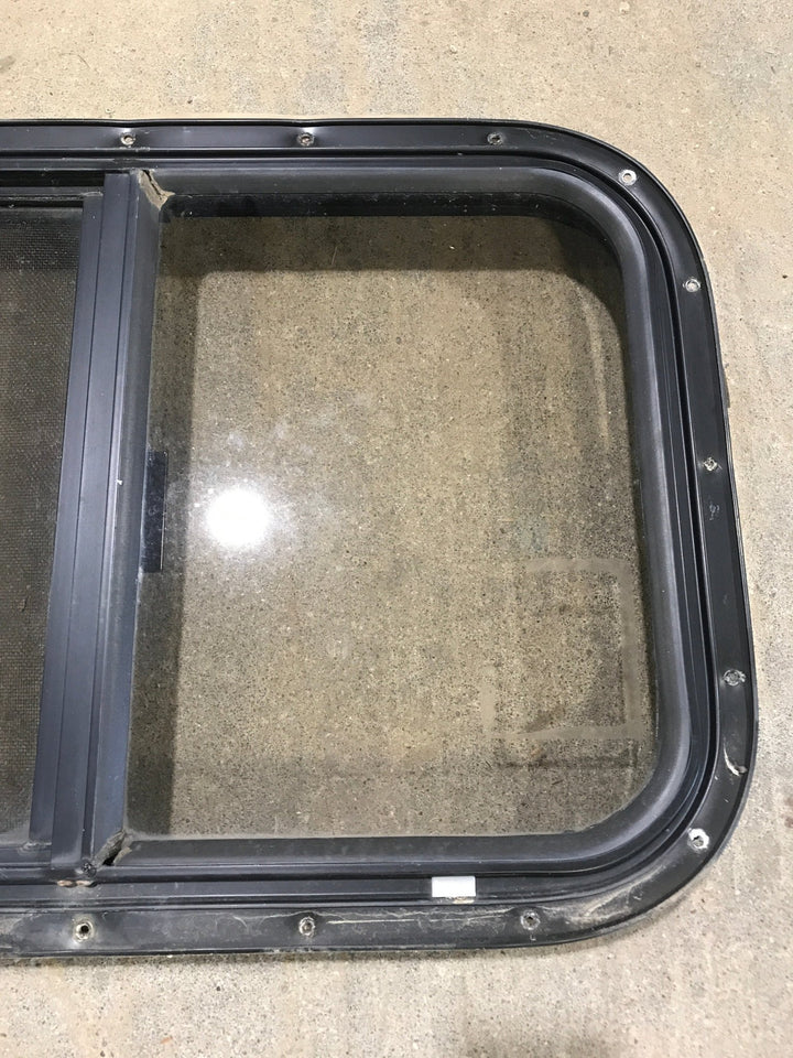 Used Black Radius Opening Window : 24 1/2" W x 19 1/4" H x 1 1/4" - Young Farts RV Parts