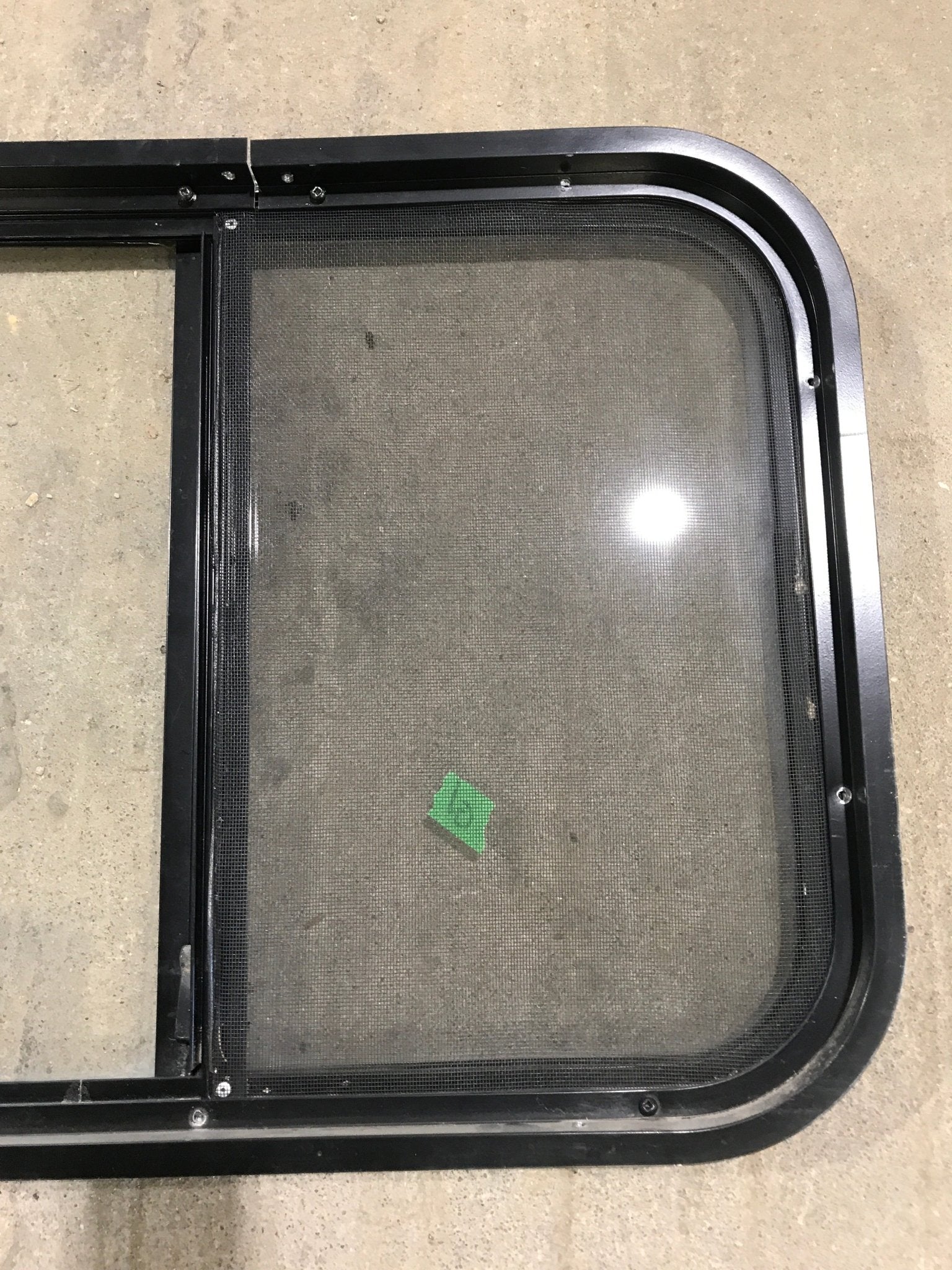 Used Black Radius Opening Window : 24 1/4" W x 17 3/4" H x 1 1/4" - Young Farts RV Parts