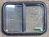Used Black Radius Opening Window : 24 1/4" W x 17 3/4" H x 1 5/8" D - Young Farts RV Parts