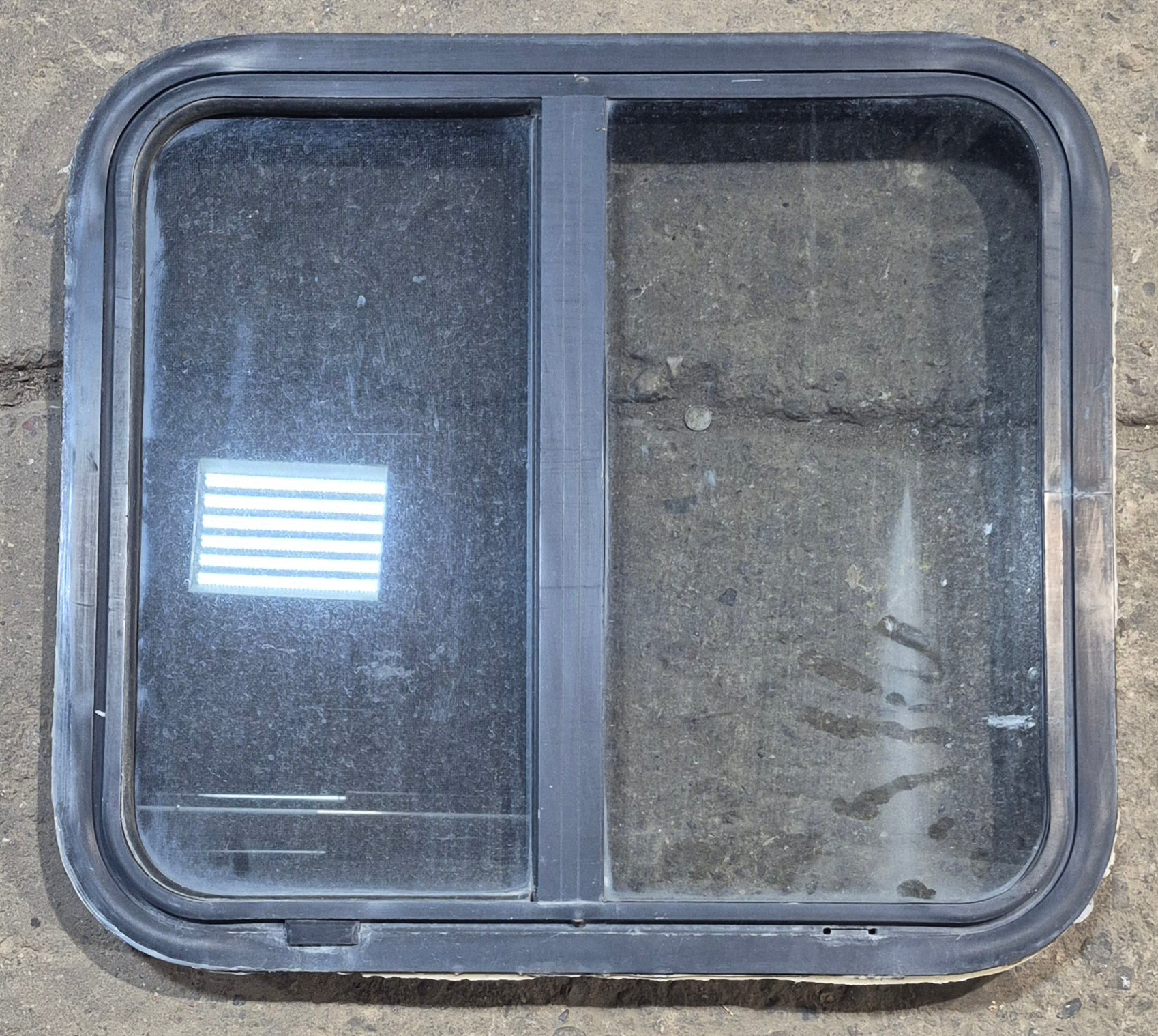 Used Black Radius Opening Window : 24 1/4" W x 21 3/4" H x 1 7/8" - Young Farts RV Parts