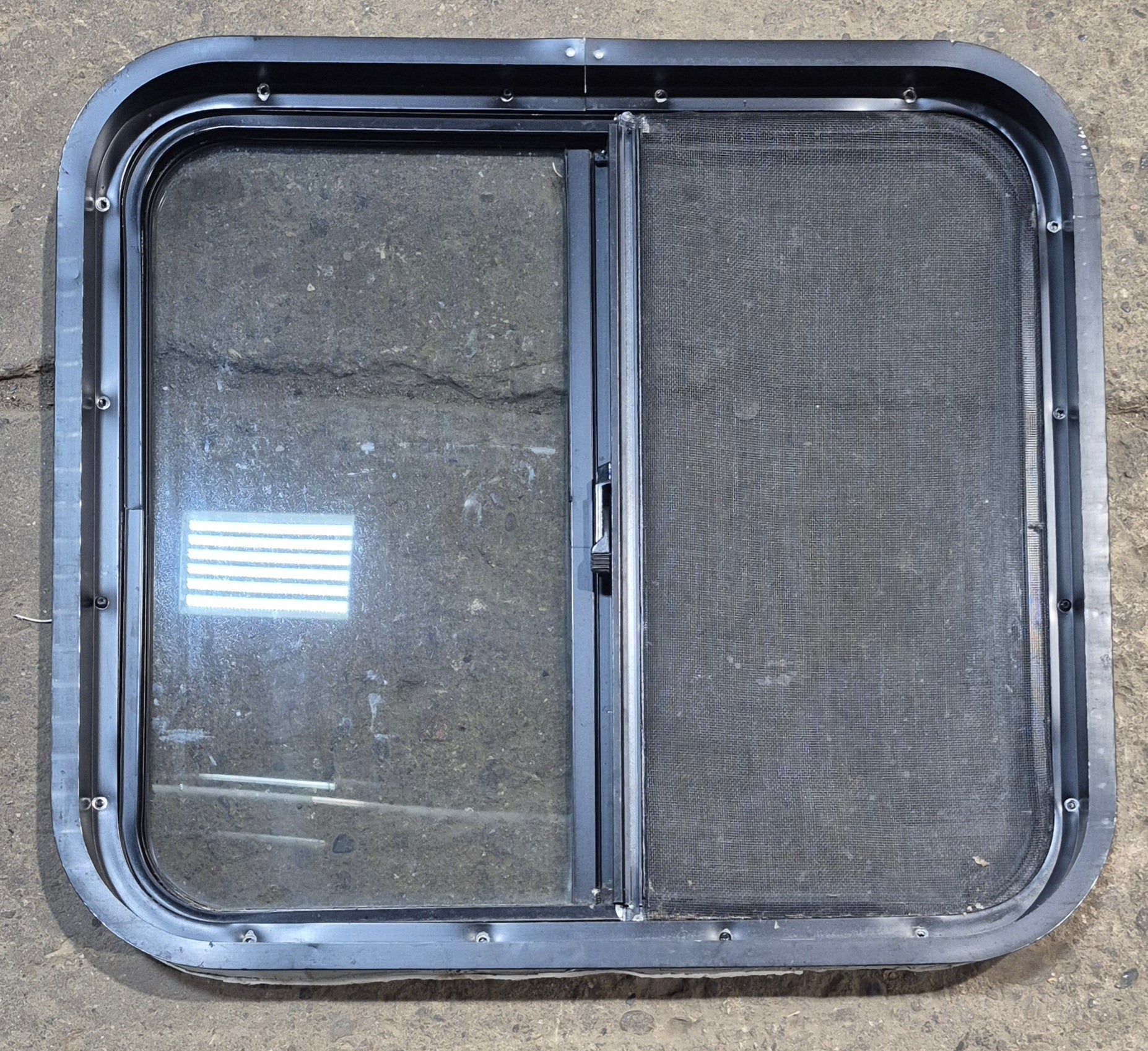 Used Black Radius Opening Window : 24 1/4" W x 21 3/4" H x 1 7/8" - Young Farts RV Parts