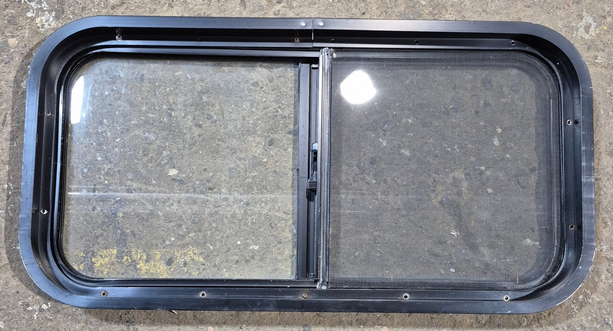 Used Black Radius Opening Window : 29 1/2" W x 14 3/4" H x 1 7/8" - Young Farts RV Parts