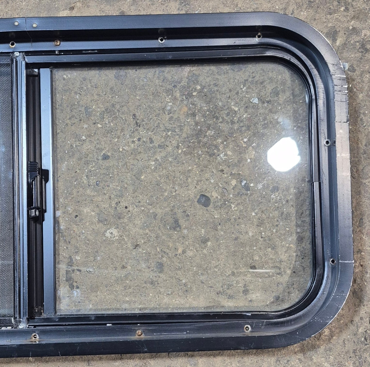 Used Black Radius Opening Window : 29 1/2" W x 14 3/4" H x 1 7/8" - Young Farts RV Parts