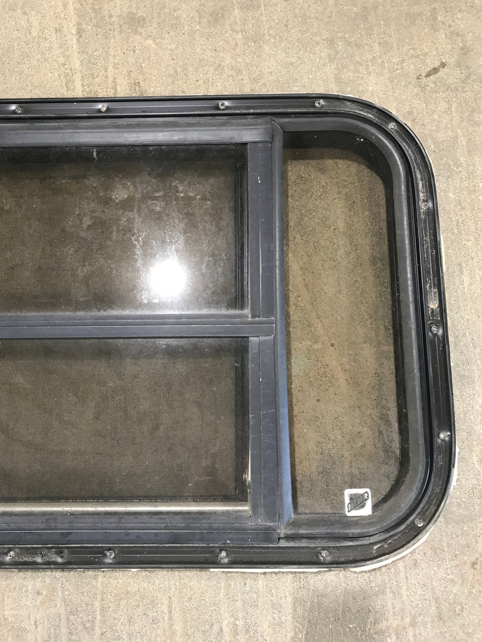 Used Black Radius Opening Window : 30 1/2" W x 18 3/4" H x 1 1/2" D - Young Farts RV Parts