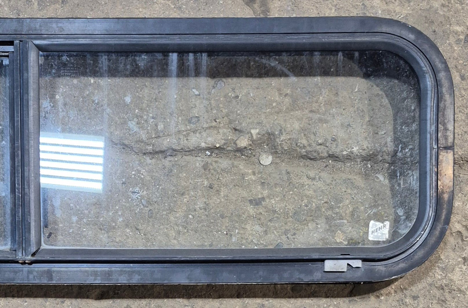 Used Black Radius Opening Window : 42 1/4" W x 11 3/4" H x 1 7/8" - Young Farts RV Parts