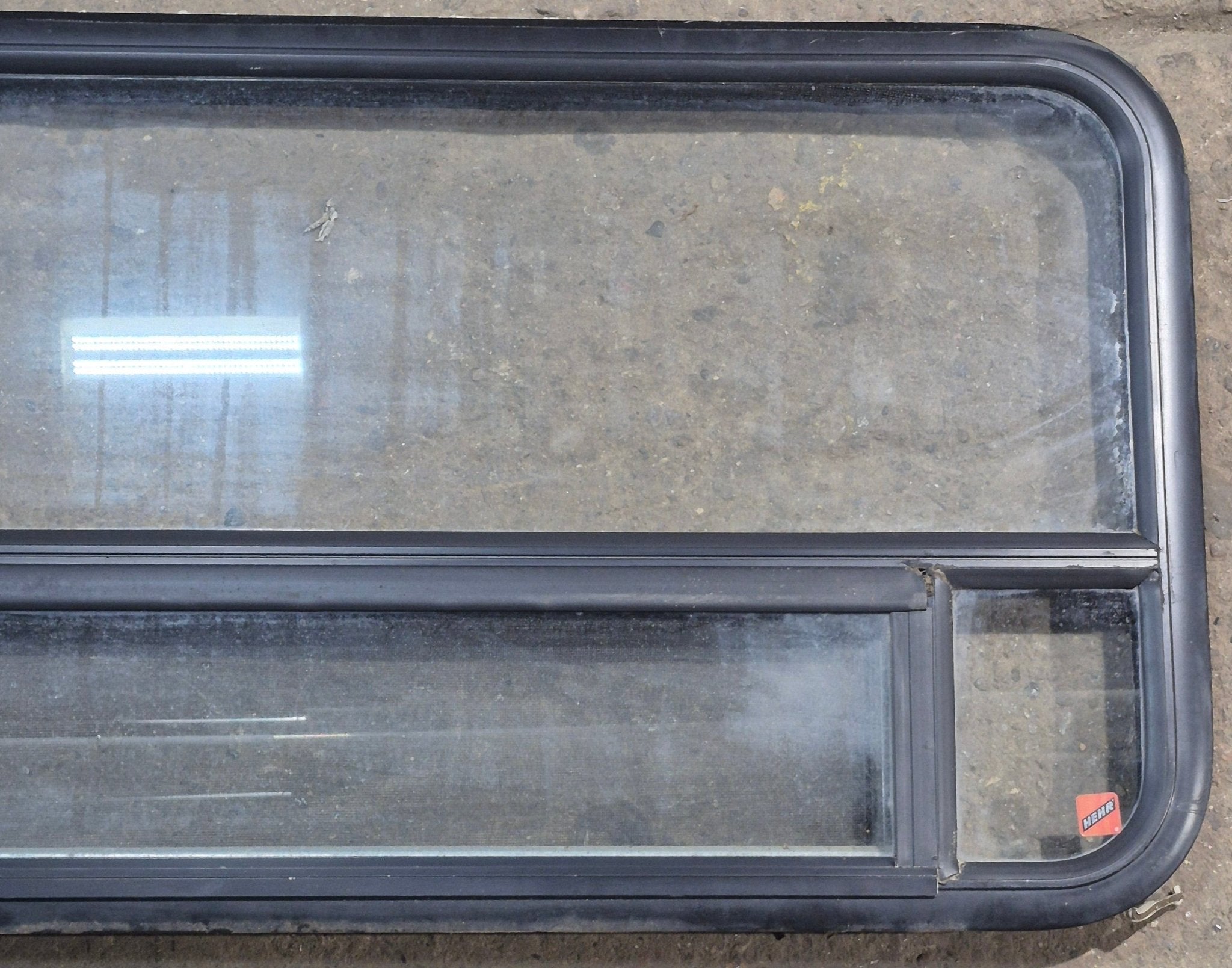 Used Black Radius Opening Window : 45 1/4" W x 21 1/4" H x 1 7/8" D - Young Farts RV Parts