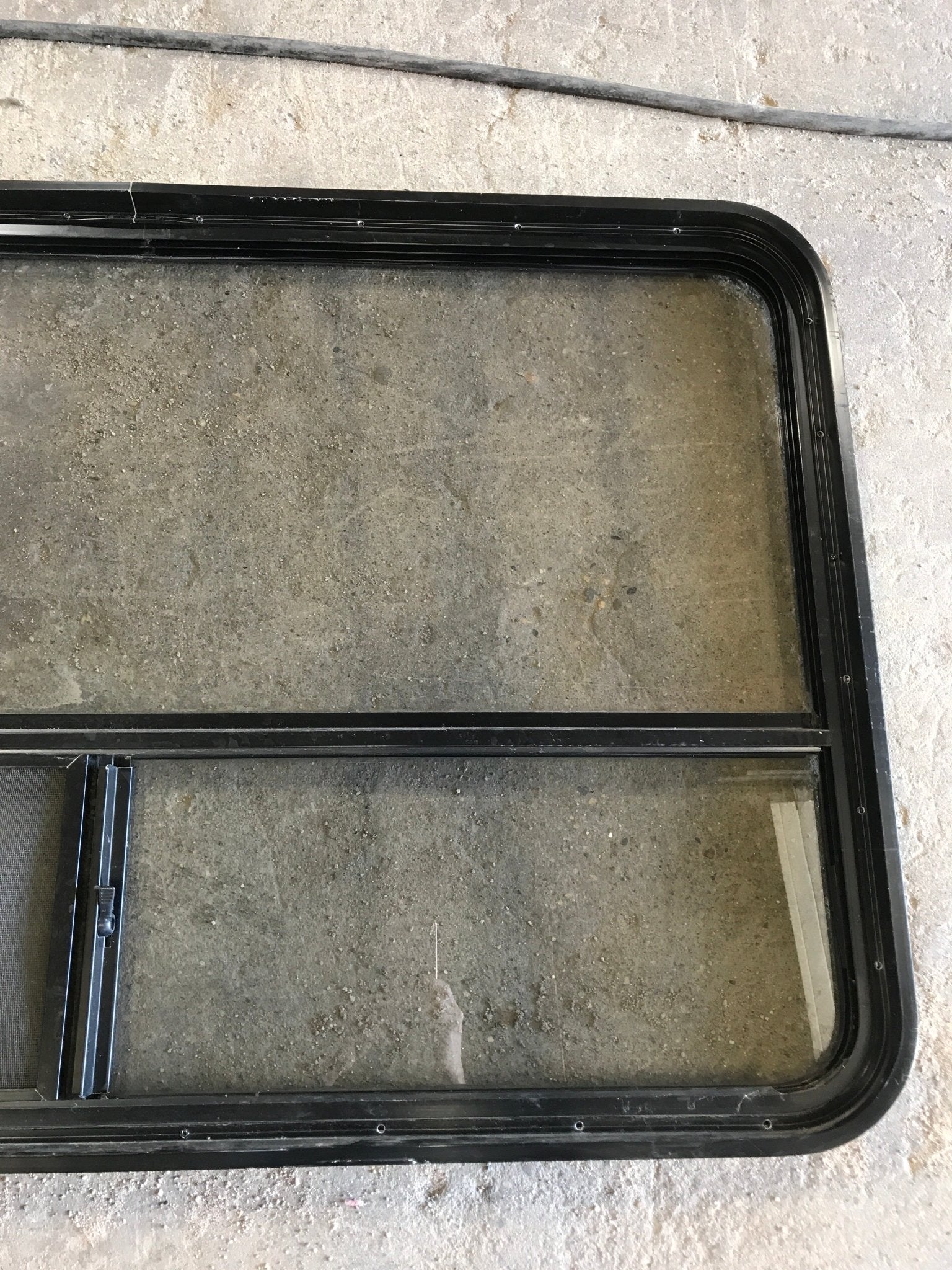 Used Black Radius Opening Window : 47 1/2" W x 30" H x 2" D - Young Farts RV Parts