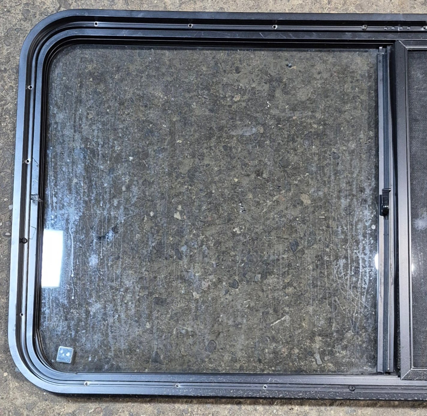 Used Black Radius Opening Window : 47 3/4" W x 23 3/4" H x 1 7/8" - Young Farts RV Parts