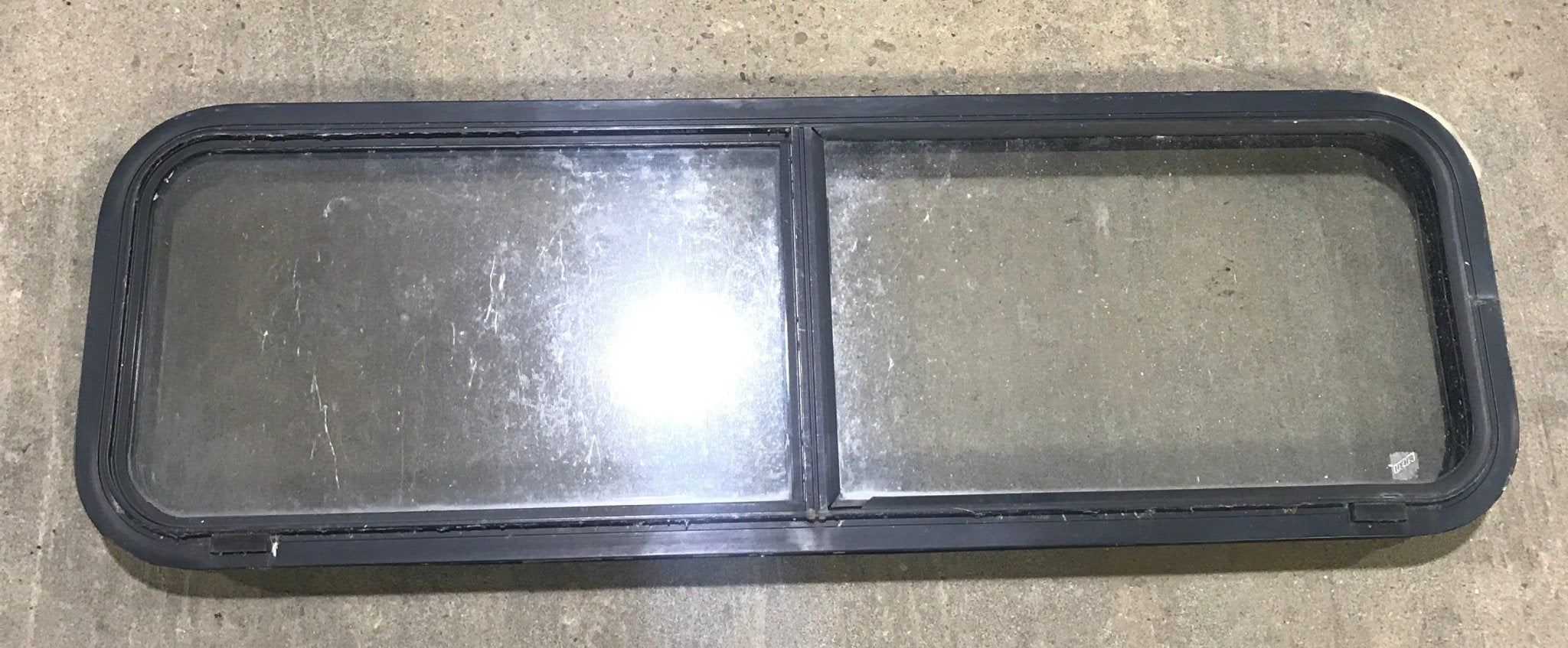Used Black Radius Opening Window : 49" W x 15 1/4" H x 2" D - Young Farts RV Parts