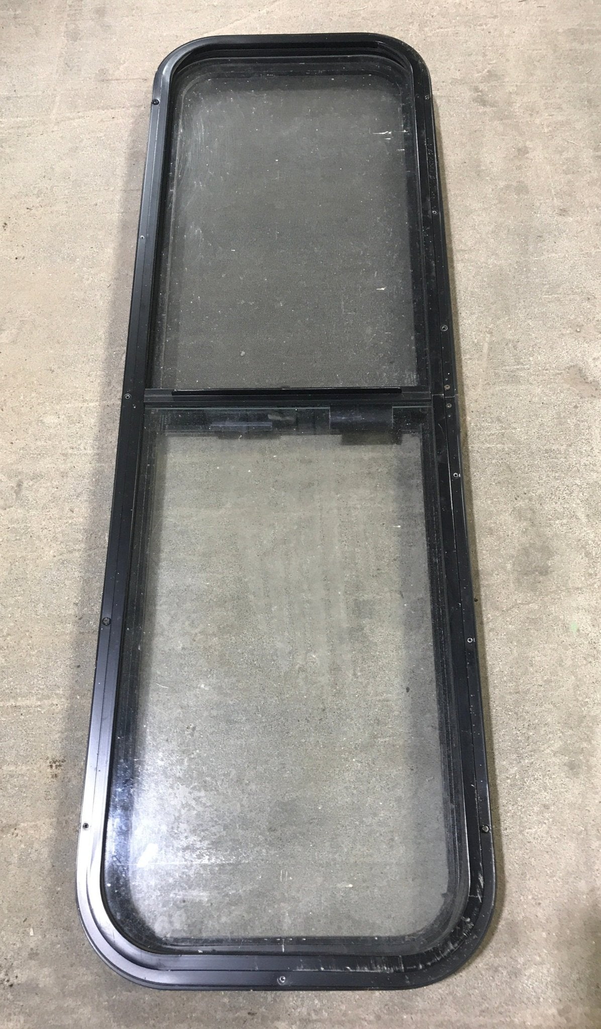 Used Black Radius Opening Window : 49" W x 15 1/4" H x 2" D - Young Farts RV Parts