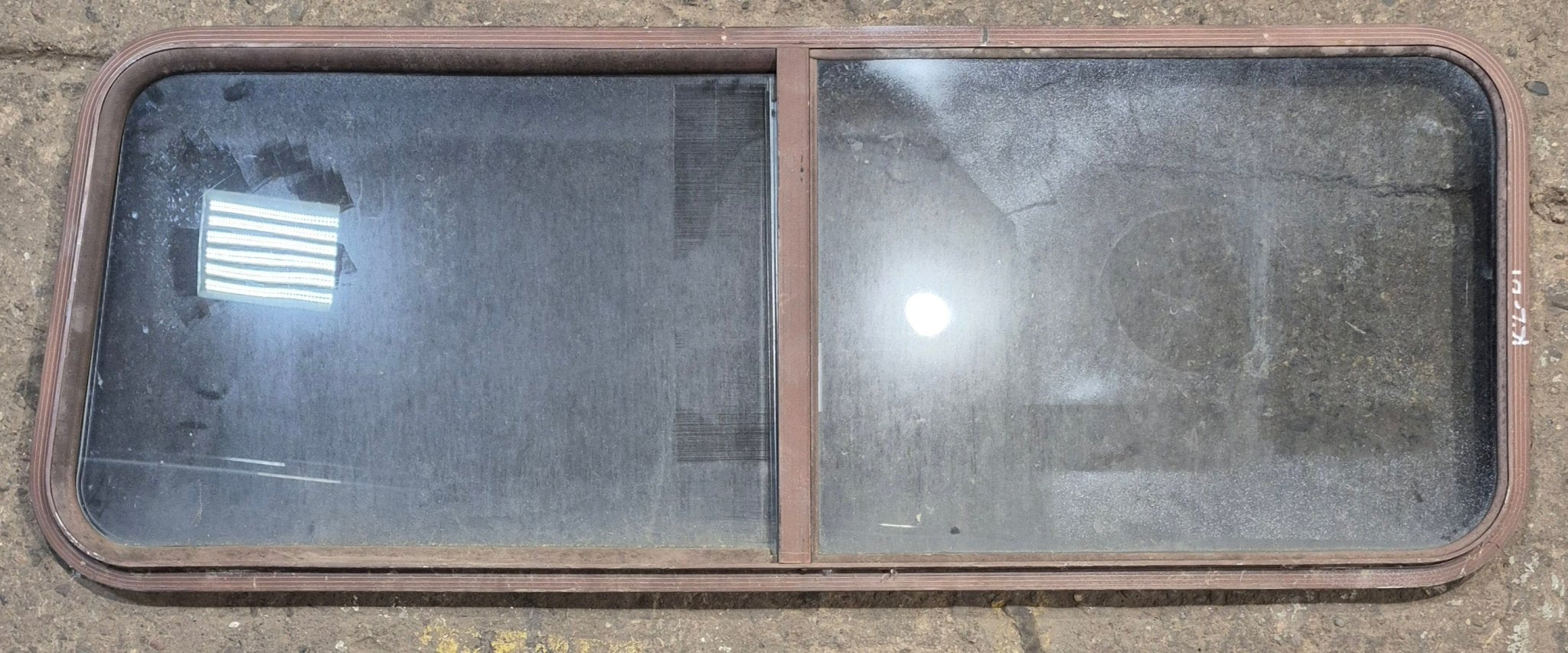 Used Slanted Brown Radius Opening Window : 55 1/2" W x 19 3/4" H x 1 1/4" D - Young Farts RV Parts