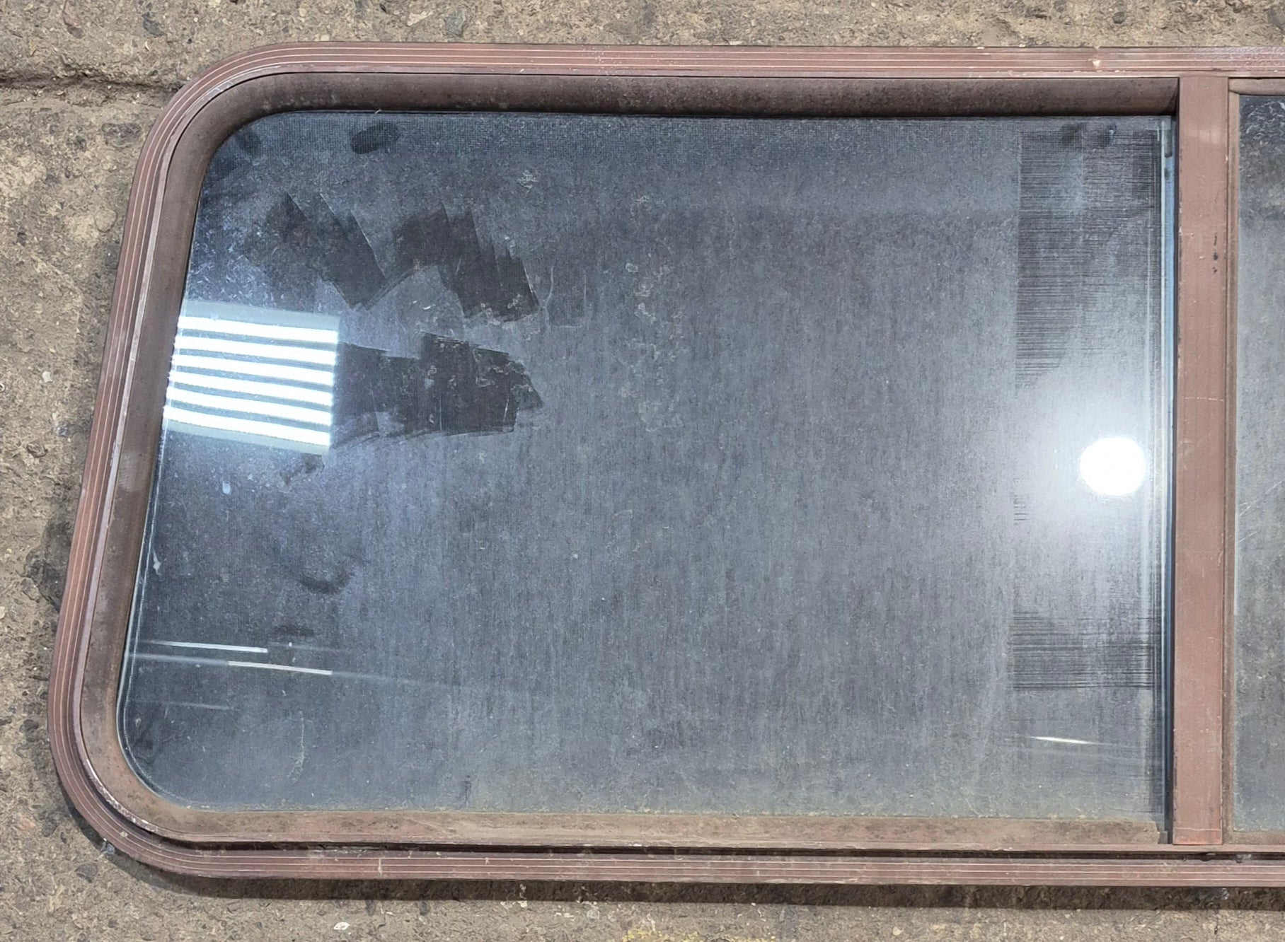 Used Slanted Brown Radius Opening Window : 55 1/2" W x 19 3/4" H x 1 1/4" D - Young Farts RV Parts