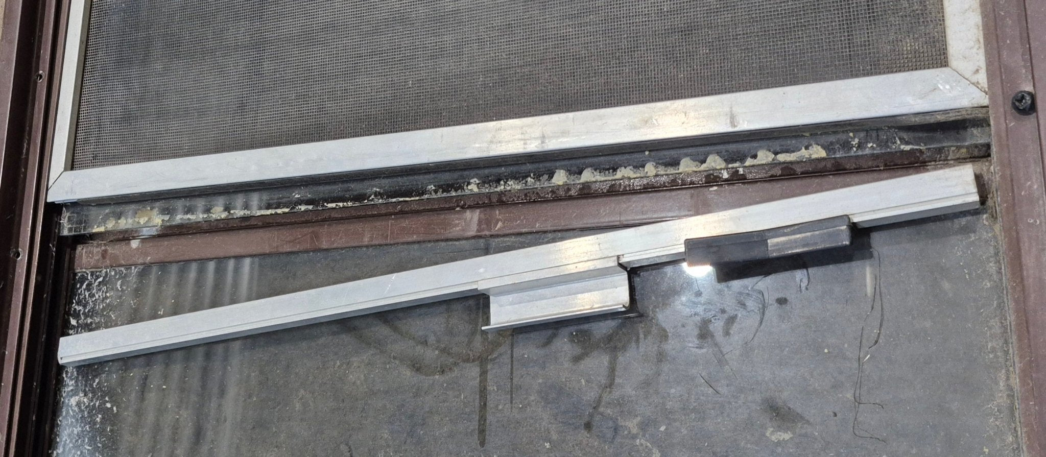 Used Slanted Brown Radius Opening Window : 55 1/2" W x 19 3/4" H x 1 1/4" D - Young Farts RV Parts