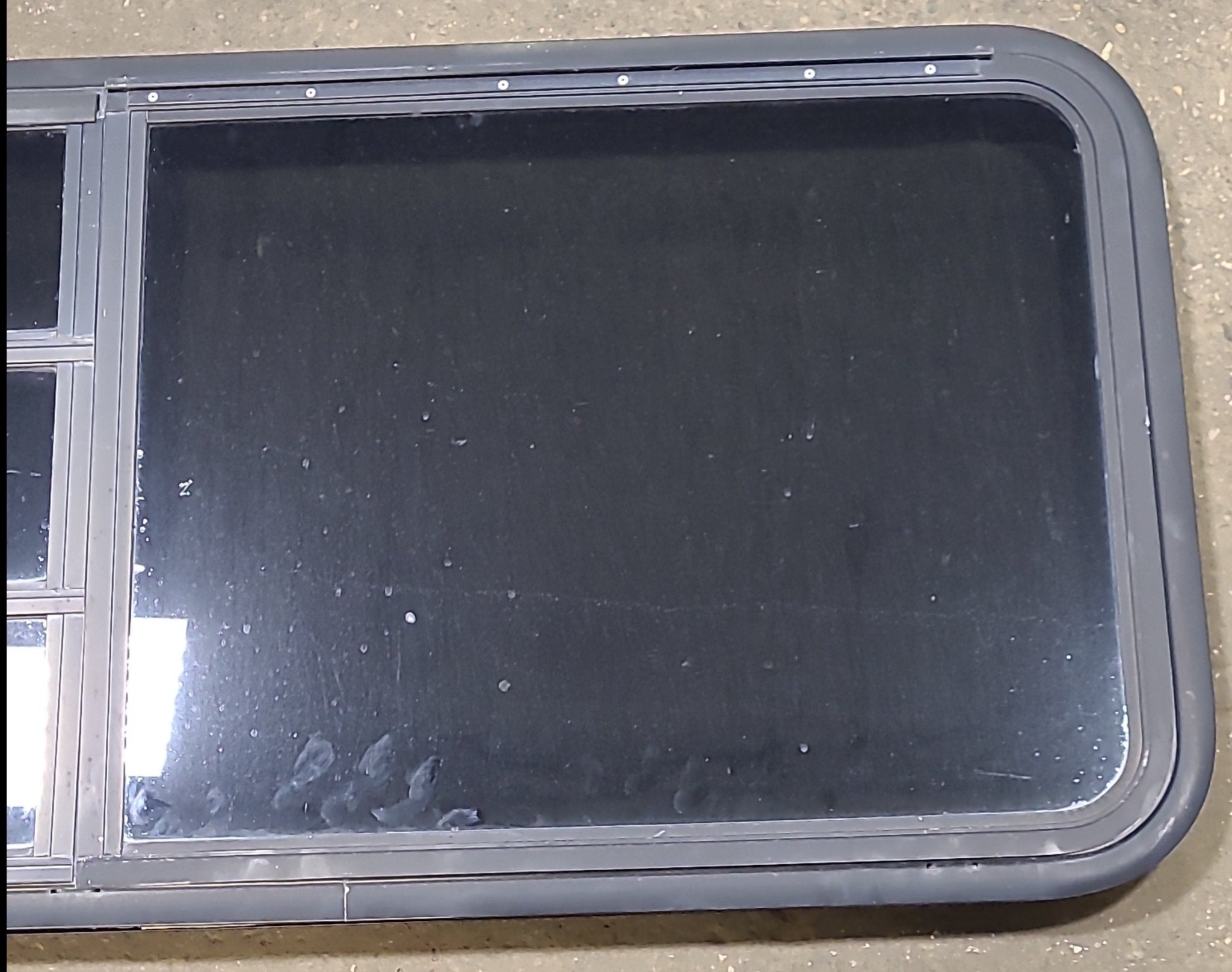 Used Black Radius Emergency Opening Window : 47 1/4" W x 22 1/2" H x 1 3/4" D - Young Farts RV Parts