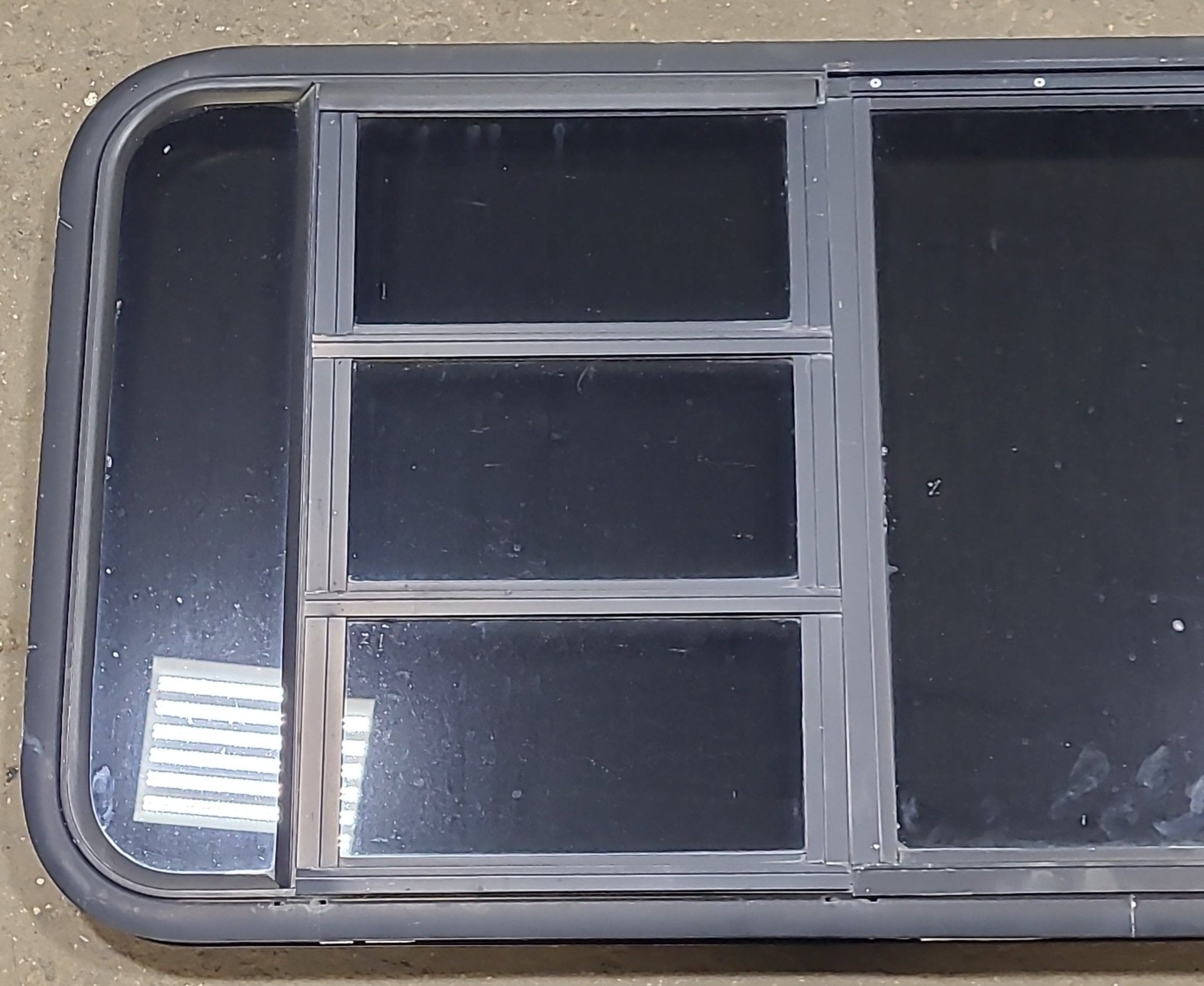 Used Black Radius Emergency Opening Window : 47 1/4" W x 22 1/2" H x 1 3/4" D - Young Farts RV Parts