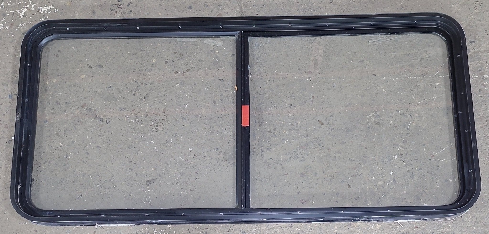 Used Black Radius Emergency Opening Window : 55 1/2" W x 25 1/2" H x 1 7/8" D - Young Farts RV Parts