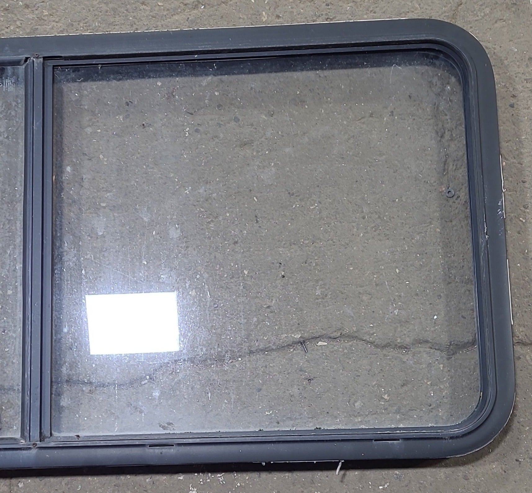 Used Black Radius Emergency Opening Window : 55 1/2" W x 25 1/2" H x 1 7/8" D - Young Farts RV Parts