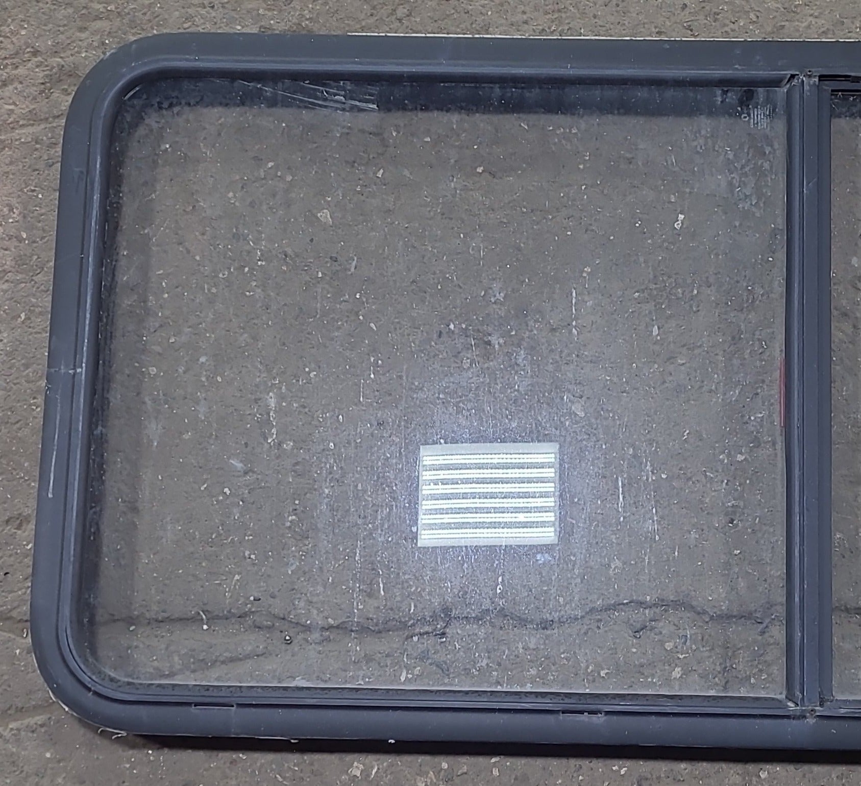 Used Black Radius Emergency Opening Window : 55 1/2" W x 25 1/2" H x 1 7/8" D - Young Farts RV Parts