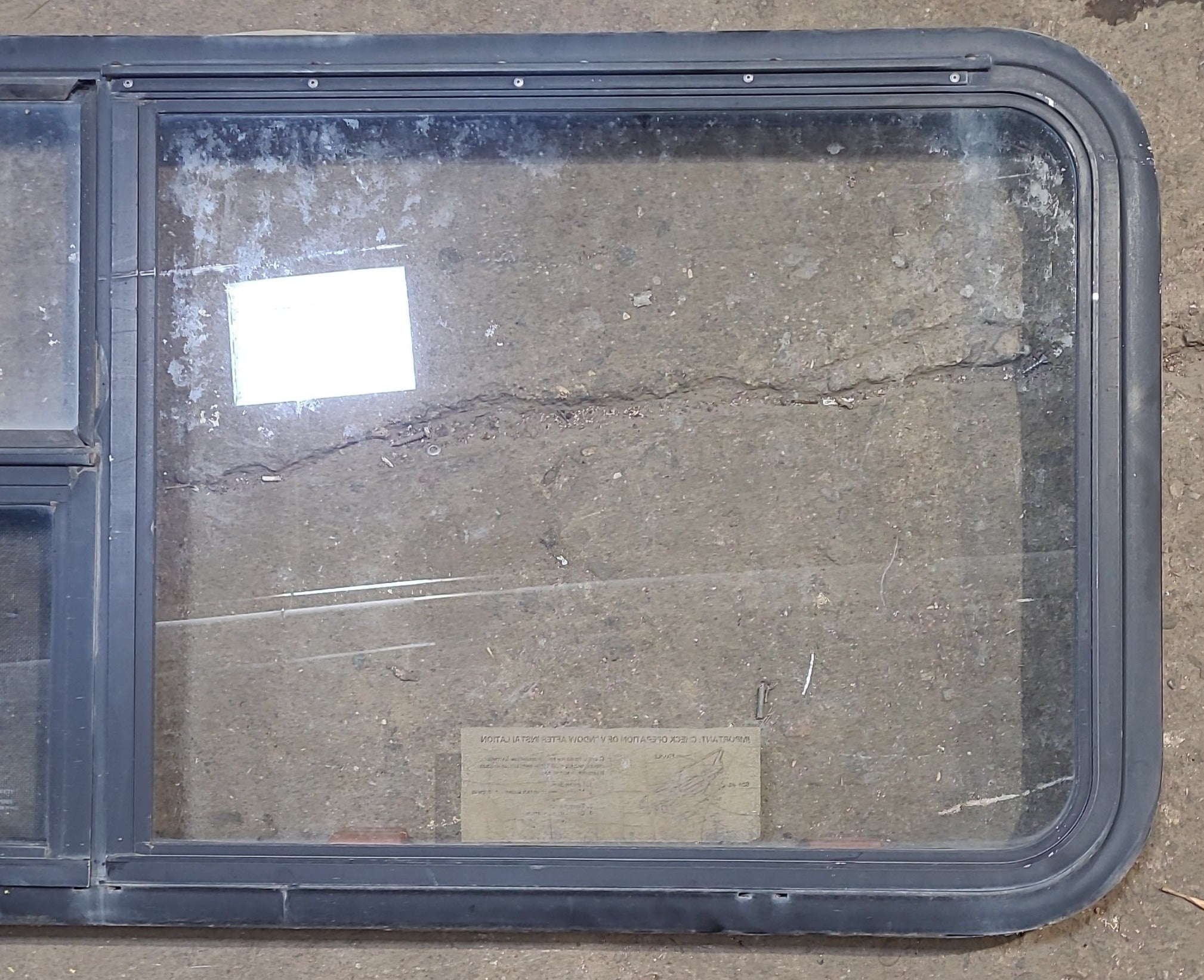 Used Black Radius Emergency Opening Window : 59 1/2" W x 21 1/2" H x 1 7/8" D - Young Farts RV Parts