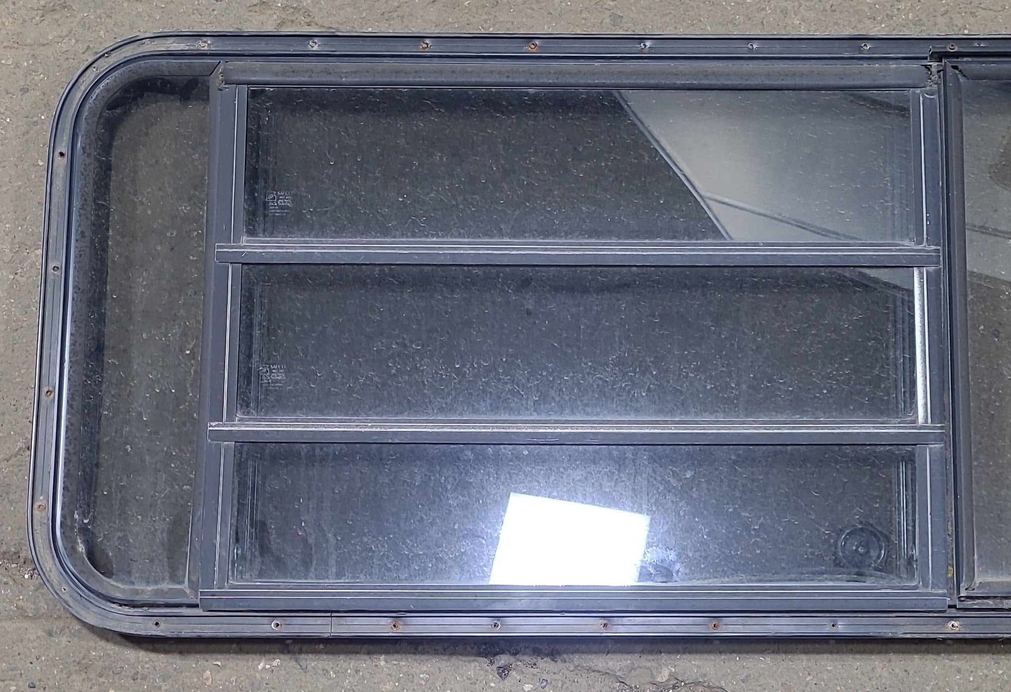 Used Black Radius Emergency Opening Window : 60 3/4" W x 23" H x 1 3/8" D - Young Farts RV Parts