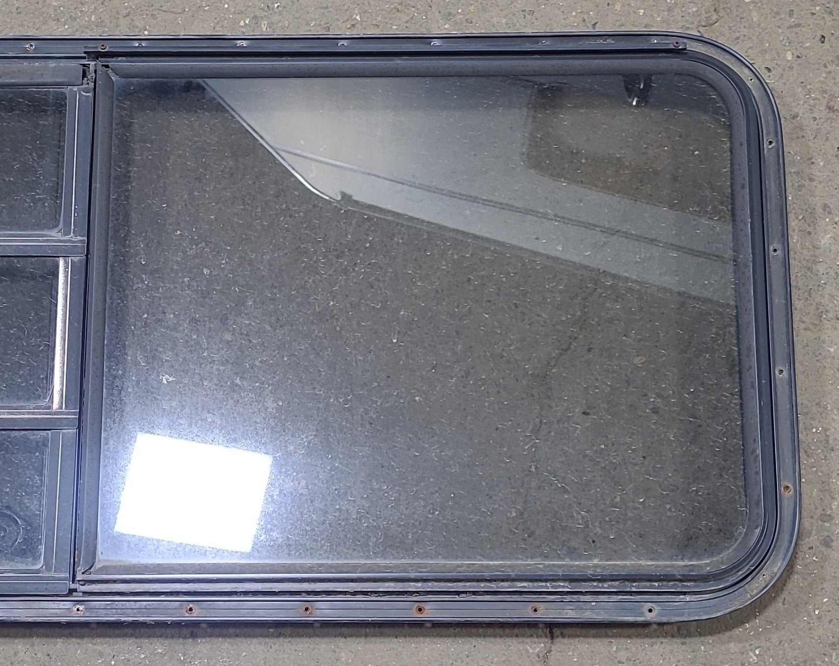 Used Black Radius Emergency Opening Window : 60 3/4" W x 23" H x 1 3/8" D - Young Farts RV Parts